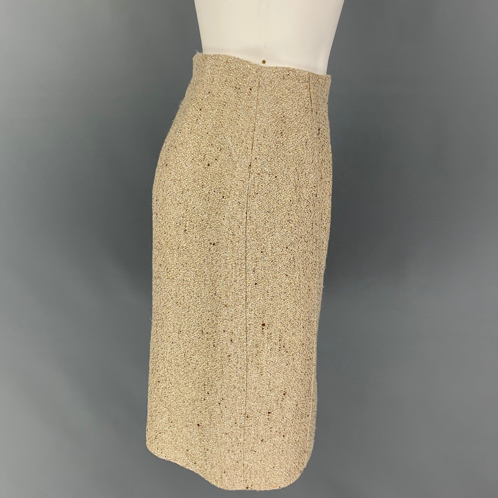 VALENTINO skirt comes in a gold textured boucle viscose blend with a slip liner featuring a pencil style, back slit, and a back zipper closure. Made in Italy.
Very Good
Pre-Owned Condition. 

Marked:   42/6 

Measurements: 
  Waist: 25 inches  Hip: