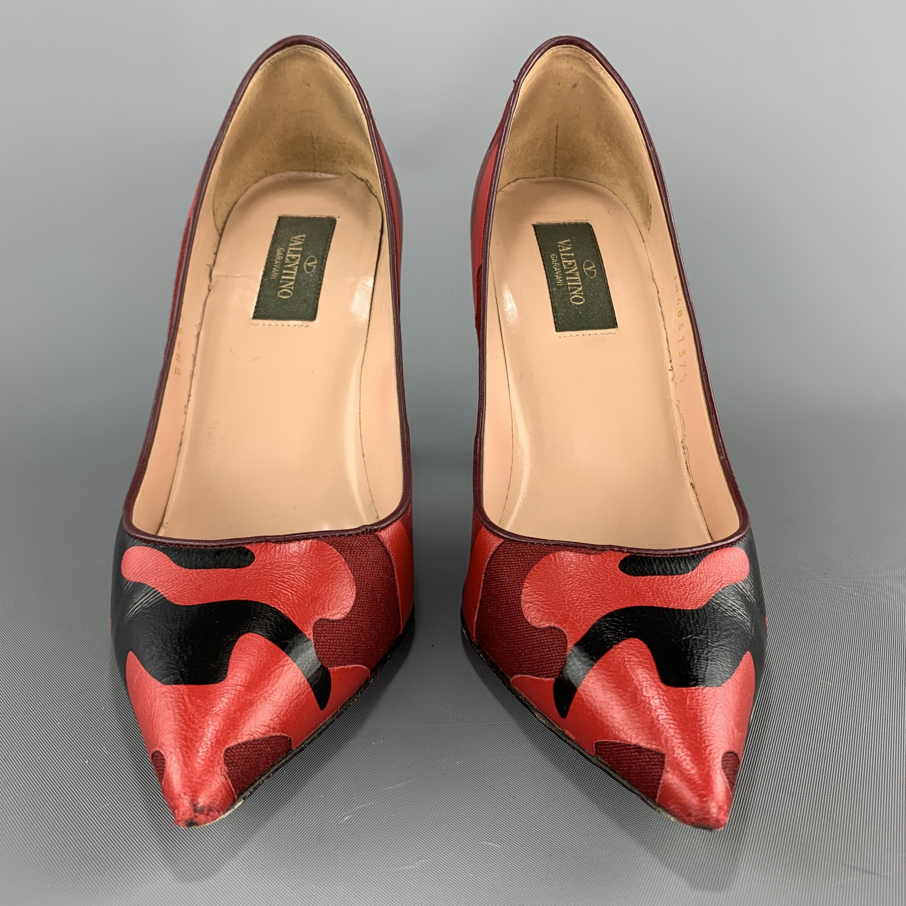 VALENTINO pumps come in red camouflage print leather and canvas with a pointed toe and rockstud heel detail. Made in Italy. 

Very Good Pre-Owned Condition.
Marked: IT 33.5

Heel: 4 in.