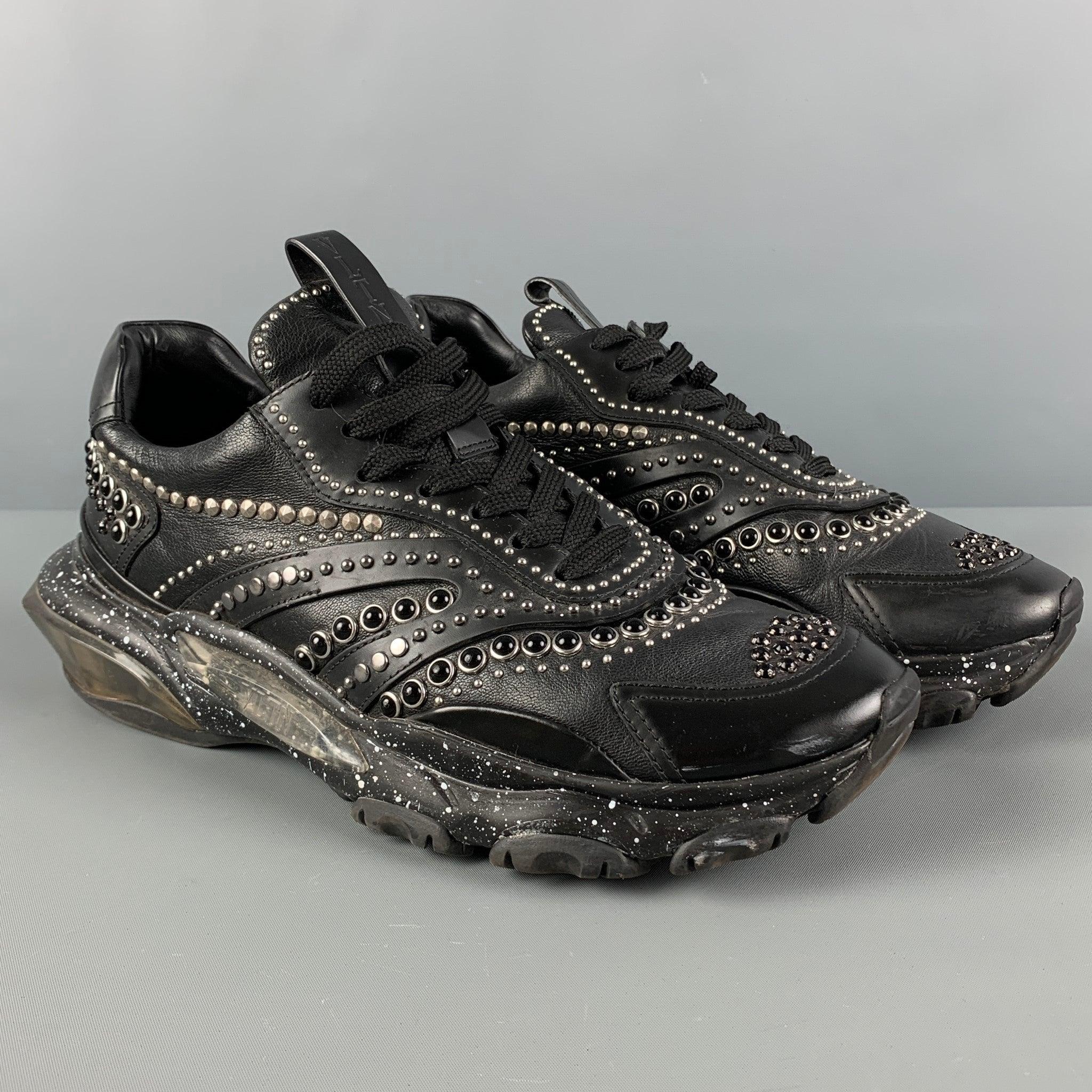 VALENTINO sneakers comes in a black leather featuring a studded design throughout, low-top, chunky sole, and a lace up closure. Made in Italy. Very Good
Pre-Owned Condition. 

Marked:  
LSQB05Y2 41Outsole: 12 inches  x 4.5 inches 
  
  
 
Reference: