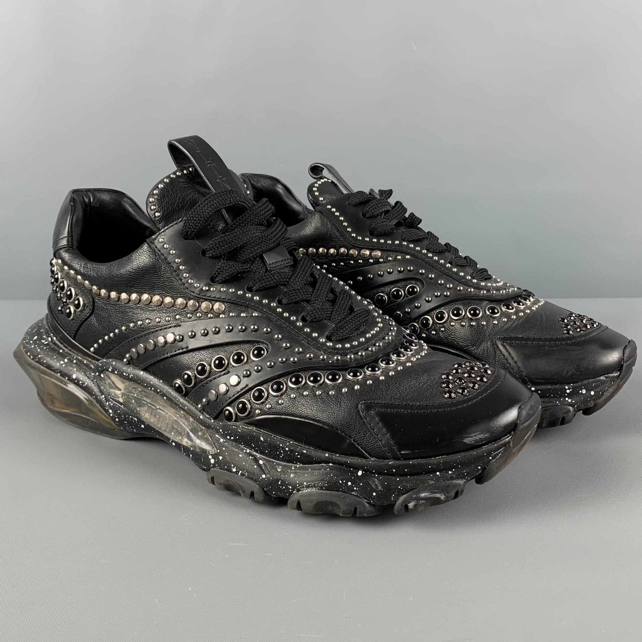 VALENTINO sneakers comes in a black leather featuring a studded design throughout, low-top, chunky sole, and a lace up closure. Made in Italy.

Very Good Pre-Owned Condition.
Marked: LSQB05Y2 41
Original Retail Price: $1,220.00

Outsole: 12 in. x