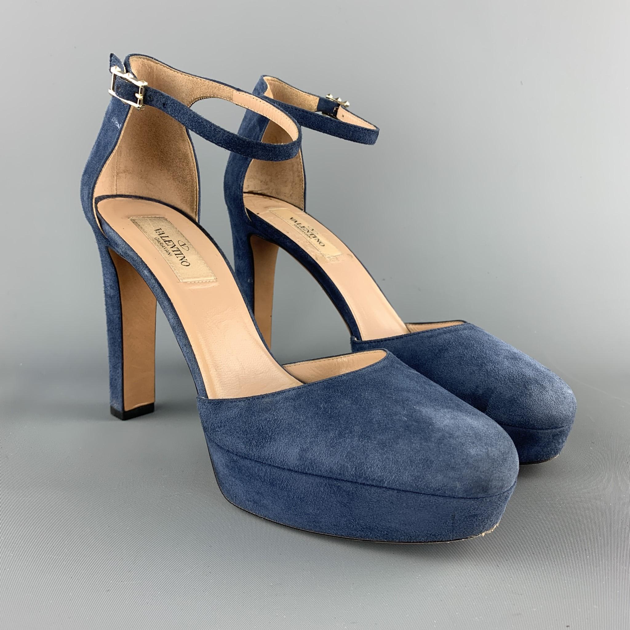 VALENTINO platform pumps come in denim blue suede with cutout sides, covered platform and heel, and ankle strap with rockstud back. Made in Italy.

Good Pre-Owned Condition.
Marked: IT 38

Heel: 4.5 in.
Platform: 1 in.
