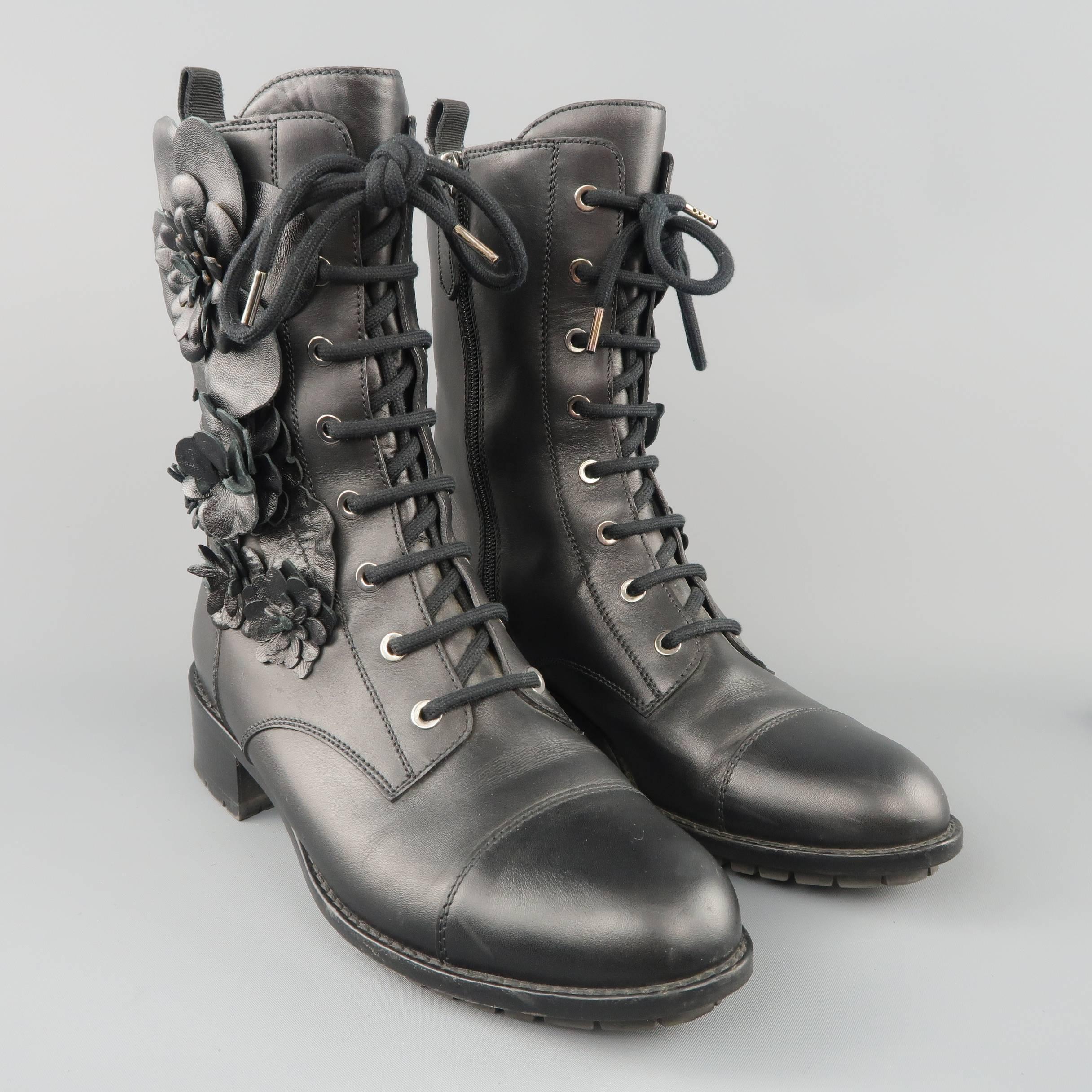 VALENTINO combat style boots come in smooth black leather with a cap toe, lace up grommet front, internal zip closure, heeled sole, and leather floral applique sides. Made in Italy.
 
Good Pre-Owned Condition.
Marked: IT 38.5
 
Measurements:
 
Heel: