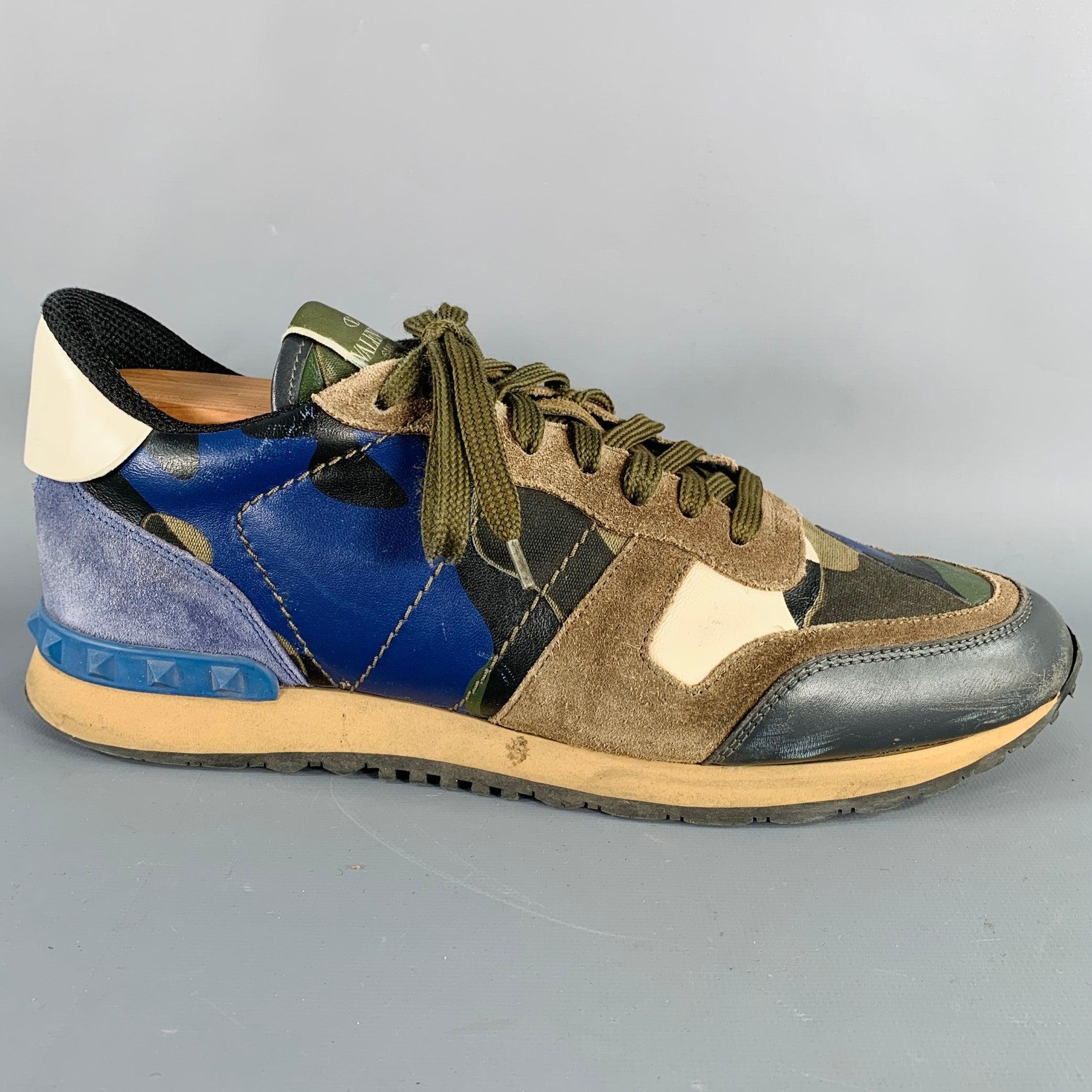 VALENTINO sneakers
in a blue and taupe suede and leather featuring a color block style, rubber Rockstud heel details, and lace-up closure. Shoe trees not included. Made in Italy.Very Good Pre-Owned Condition. Moderate signs of wear. 

Marked:  