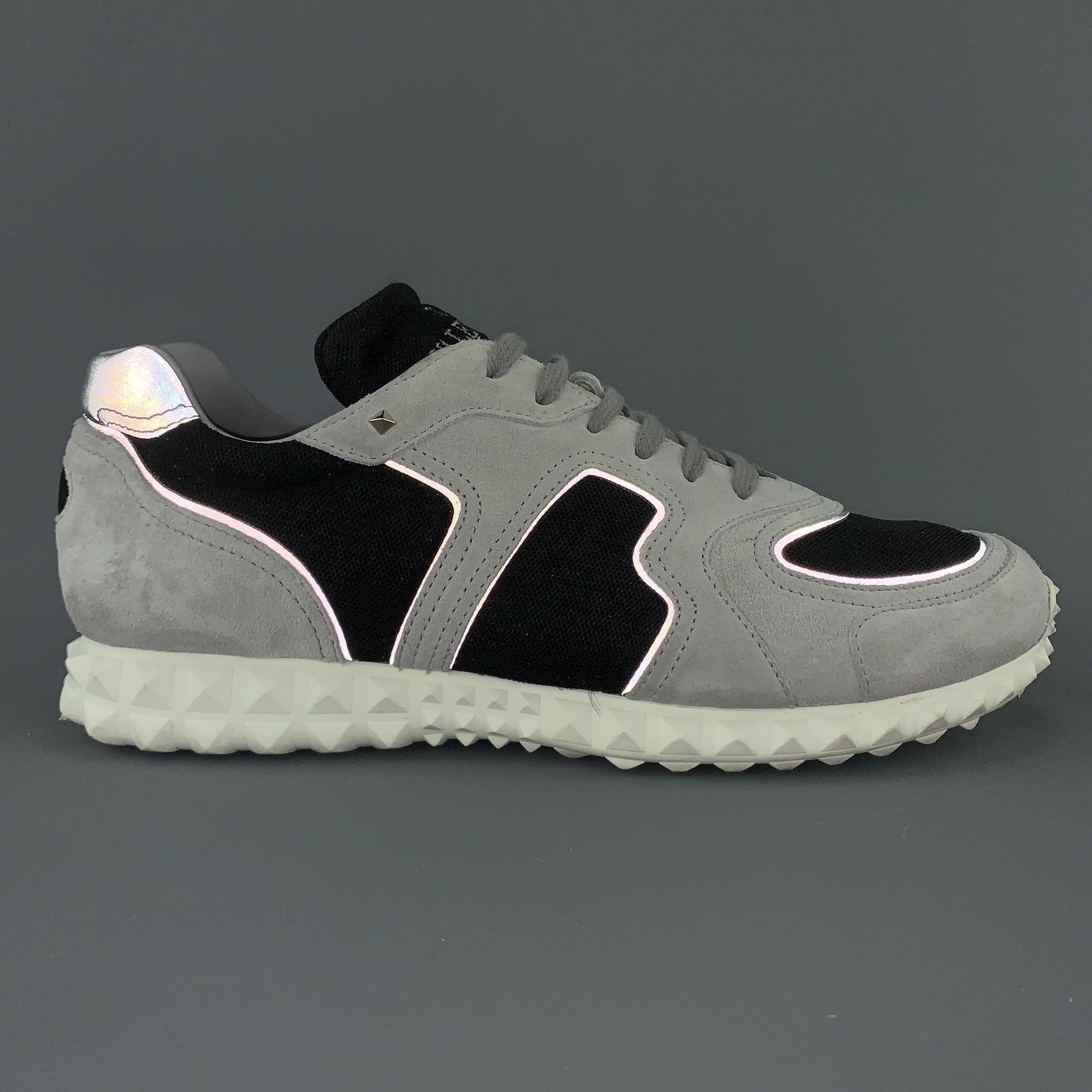 VALENTINO GARAVANI sneakers come in light gray suede with black mesh panels, reflective piping, and white Rockstud texture rubber sole. Made in Italy.

Very Good Pre-Owned Condition.
Marked: IT 42.5

Outsole: 11.5 x 4 in.