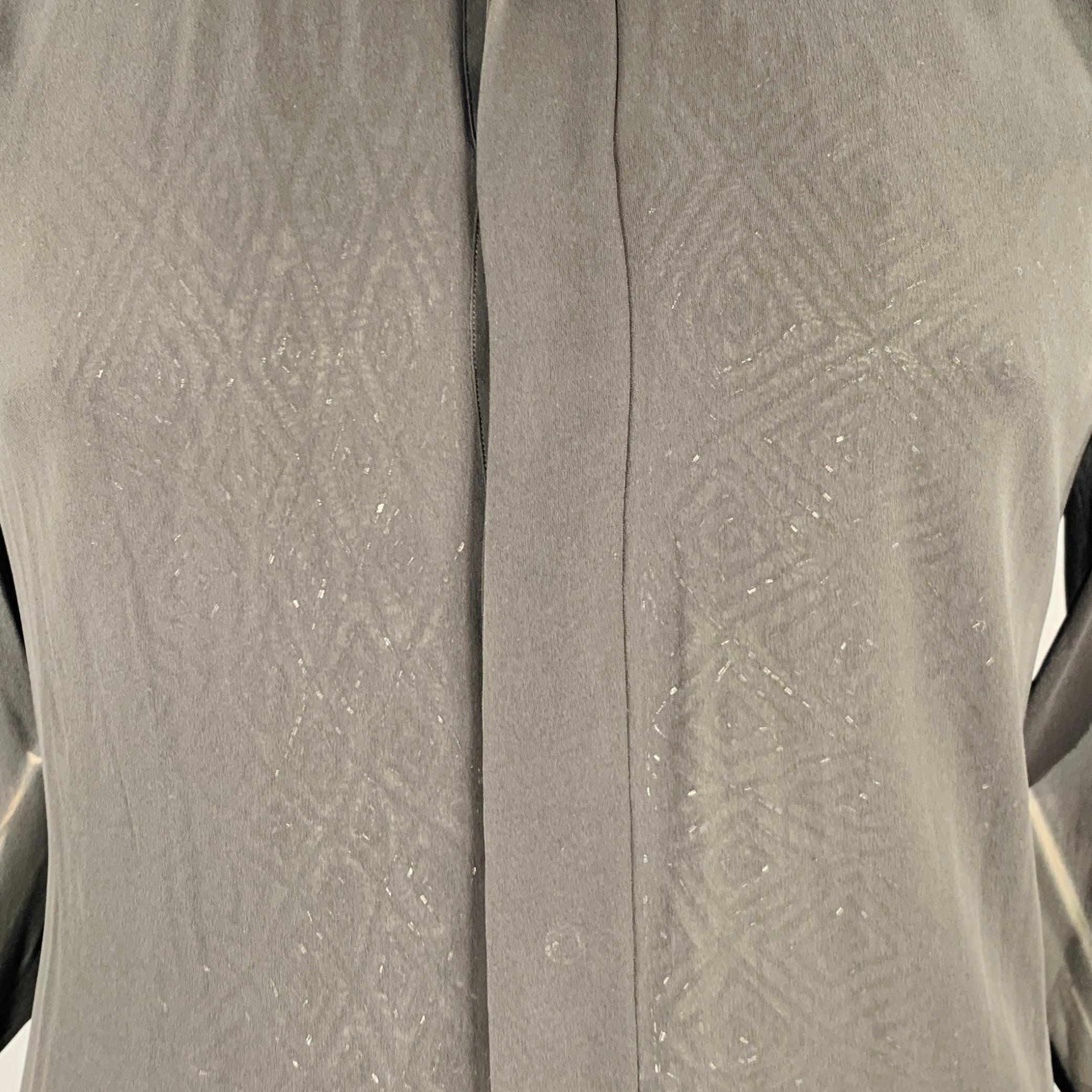 VALENTINO long sleeve shirt in black acrylic silk blend fabric featuring sheer style, subtle diamond pattern sequin underlay, French cuffs, and hidden button closure. Made in Italy.Very Good Pre-Owned Condition. Minor signs of wear. 

Marked:  