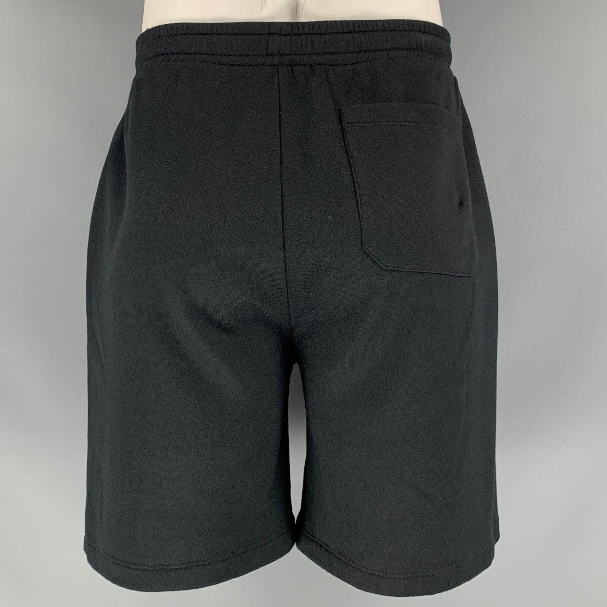 VALENTINO 'VLTN' shorts comes in a cotton polyamide material featuring a drawstring and an elastic waistband. Made in Italy.Excellent Pre-Owned Condition. 

Marked:   M 

Measurements: 
  Waist: 33 inches Rise: 16 inches Inseam: 7.5 inches 
  
  
