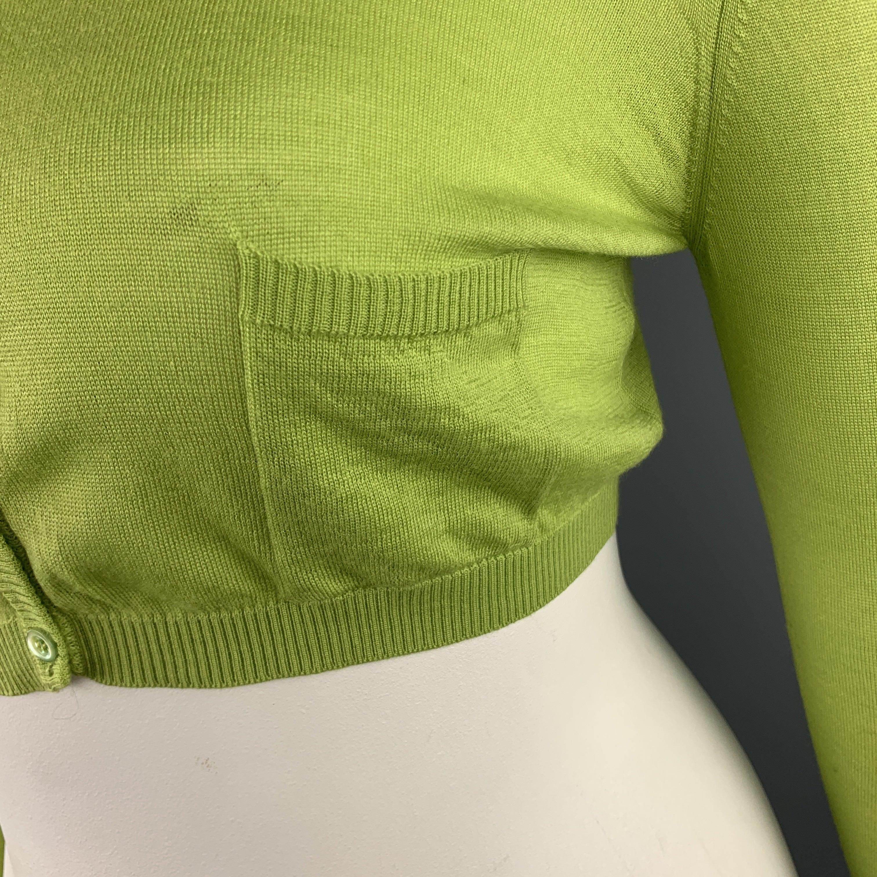 VALENTINO cardigan comes in lime green wool blend knit with a round neck, cropped hem, and patch pocket. Made in Italy.
Very Good Pre-Owned Condition. 

Marked:   L 

Measurements: 
 
Shoulder: 17 inches Bust: 36 inches Sleeve: 18 inches Length: