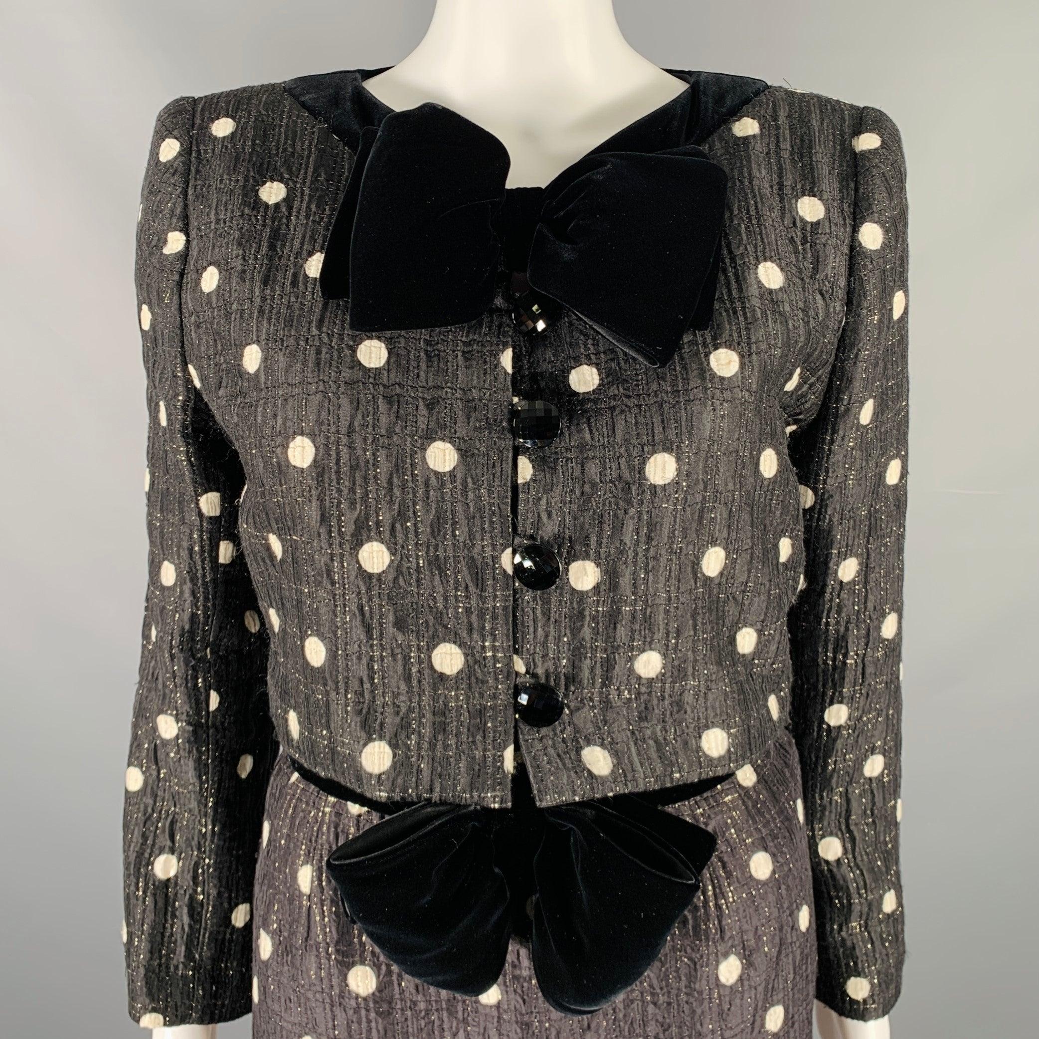 NIGHT by VALENTINO
dress & jacket set in a black and white polka dot fabric and includes a collarless bow cropped jacket with snap & button closure and matching strapless lace dress with side zipper closure. Made in Italy.Very Good Pre-Owned