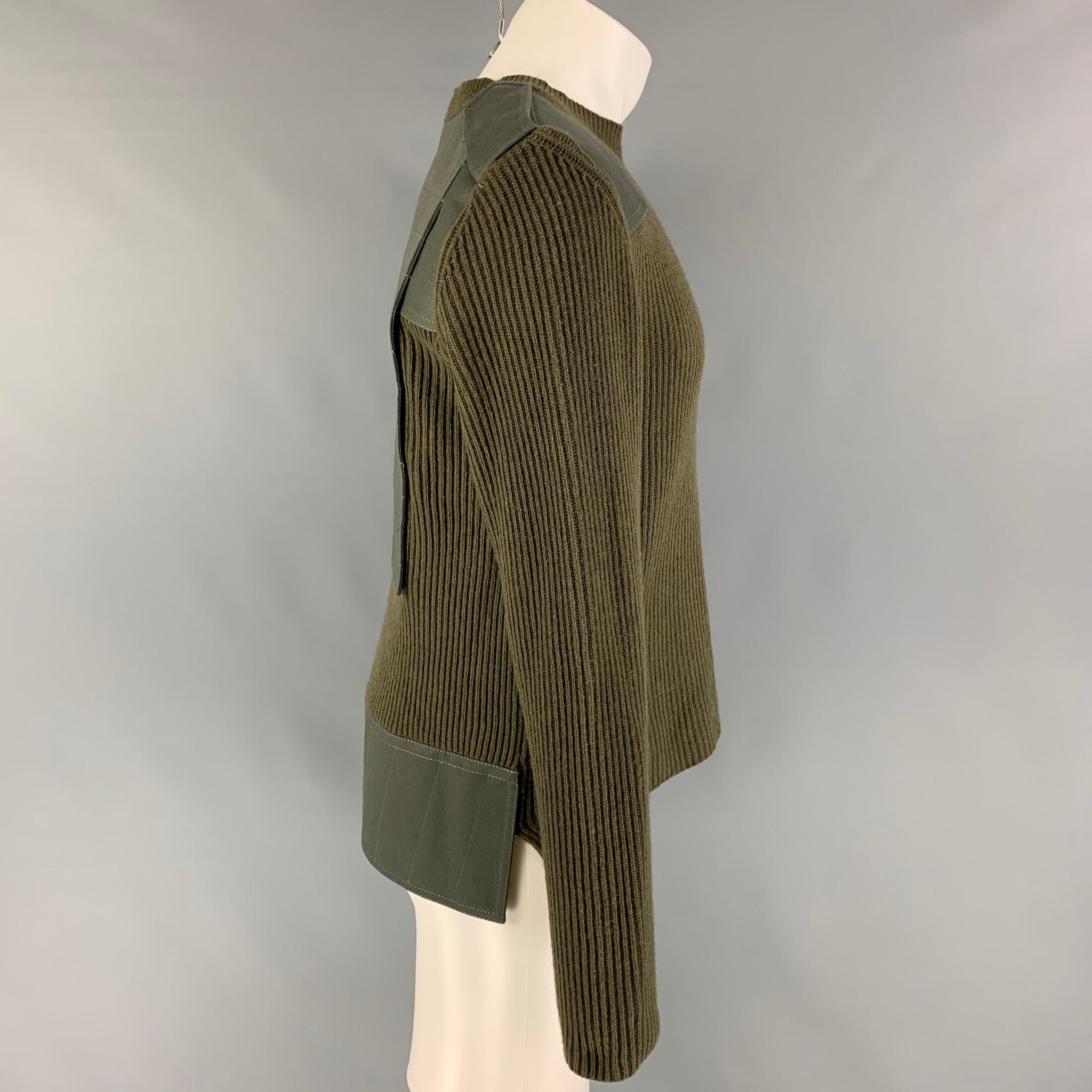 VALENTINO sweater comes in a green ribbed wool / cashmere featuring a military inspired design, stitched panels, and a crew-neck. Made in Italy. 

Very Good Pre-Owned Condition.
Marked: M
Original Retail Price: $1,440.00

Measurements:

Shoulder: 19