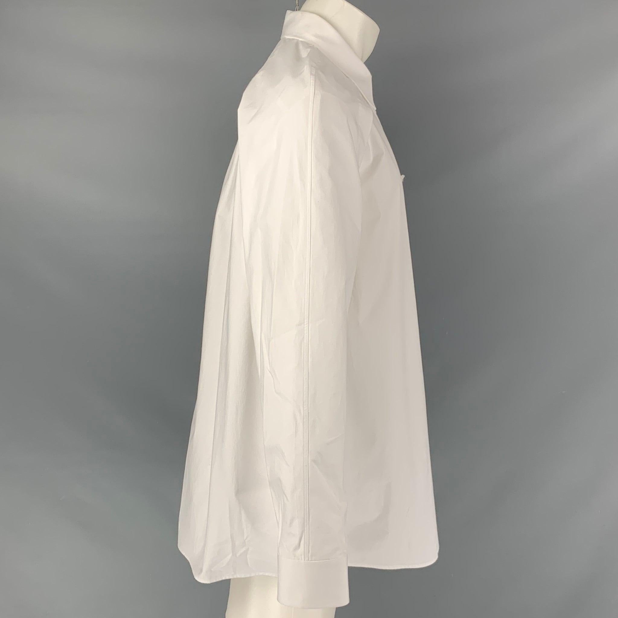 VALENTINO long sleeve shirt comes in a white cotton fabric featuring a double layer, straight collar top layer, banded collar at bottom layer, and a button down closure. Made in Italy.New with Tags. Minor mark at left cuff. 

Marked:   40- 15 3/4