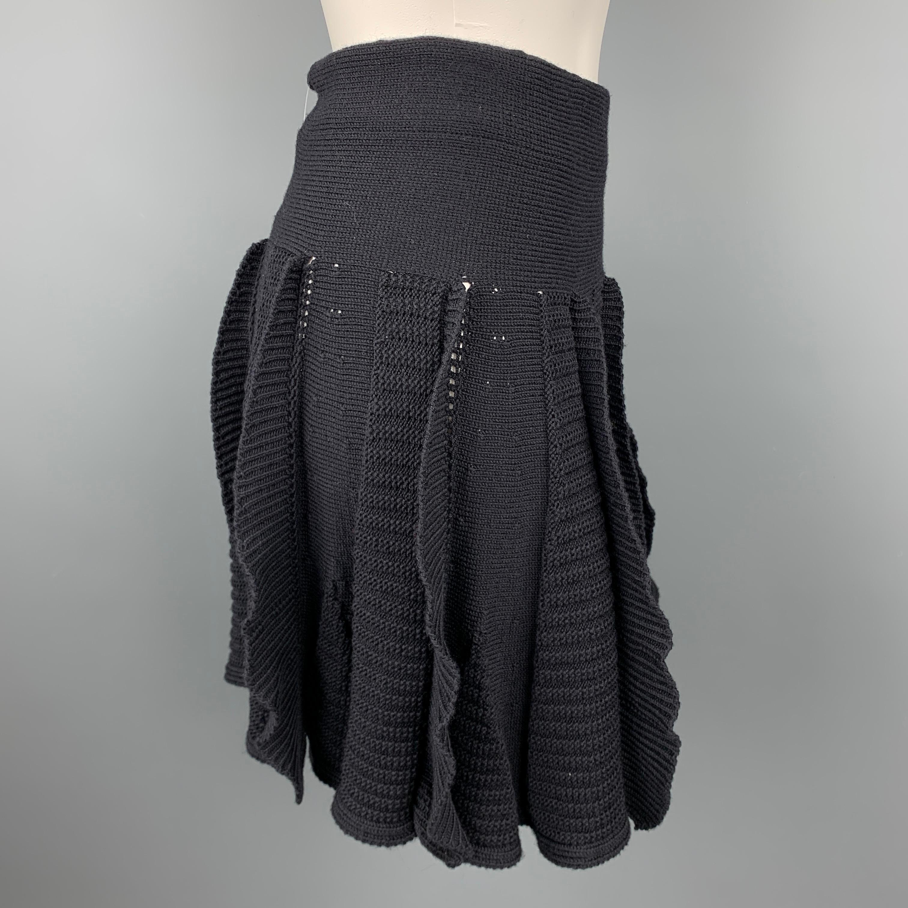 VALENTINO skirt comes in a black knitted textured virgin wool featuring a high waisted circle style. Made in Italy.

Very Good Pre-Owned Condition.
Marked: S

Measurements:

Waist: 24 in. 
Hip: 34 in. 
Length: 18.5 in. 