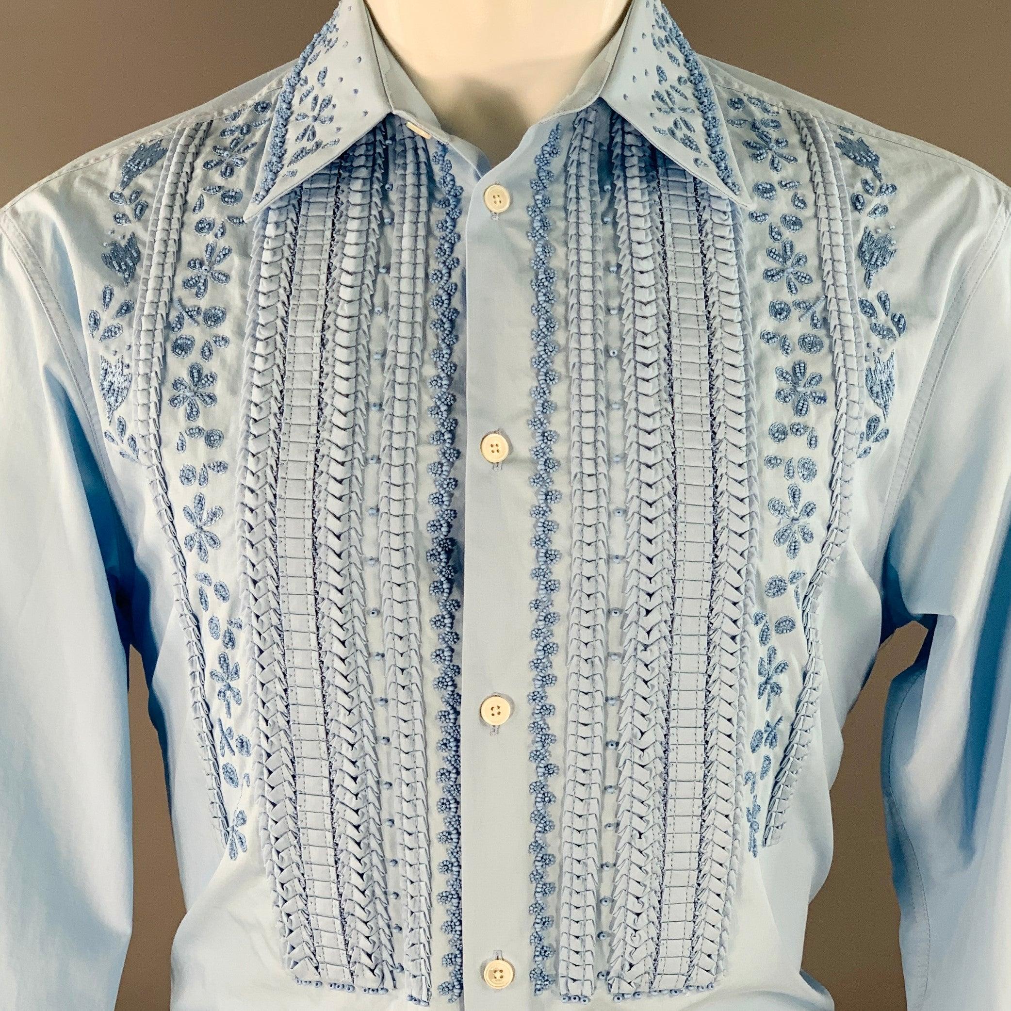 VALENTINO tuxedo long sleeve shirt
in a blue cotton woven fabric featuring a stunning floral embroidered design with beaded and pleated details, single button angled barrel cuffs, and button closure. Made in Italy.Good Pre-Owned Condition. Minor