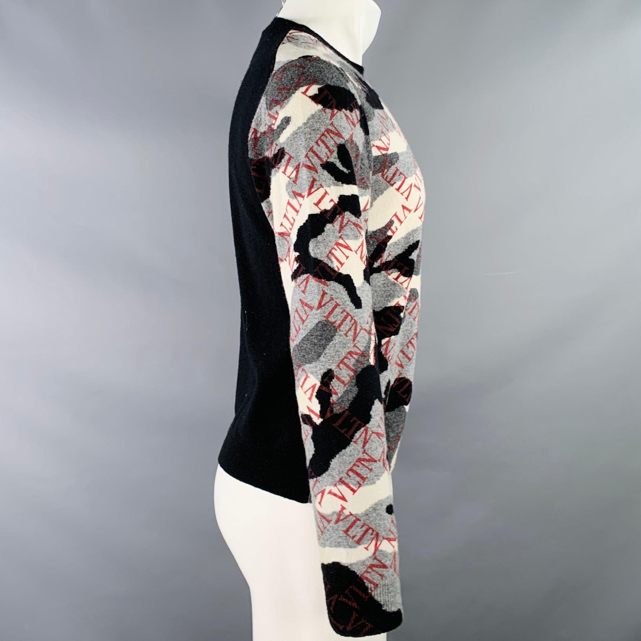 VALENTINO pullover
in a grey, black, and white cashmere knit featuring a camouflage pattern with red VLTN logo grid, long sleeves, and crew neck. Made in Italy.Very Good Pre-Owned Condition. Minor pilling. 

Marked:   S 

Measurements: 
 
Shoulder: