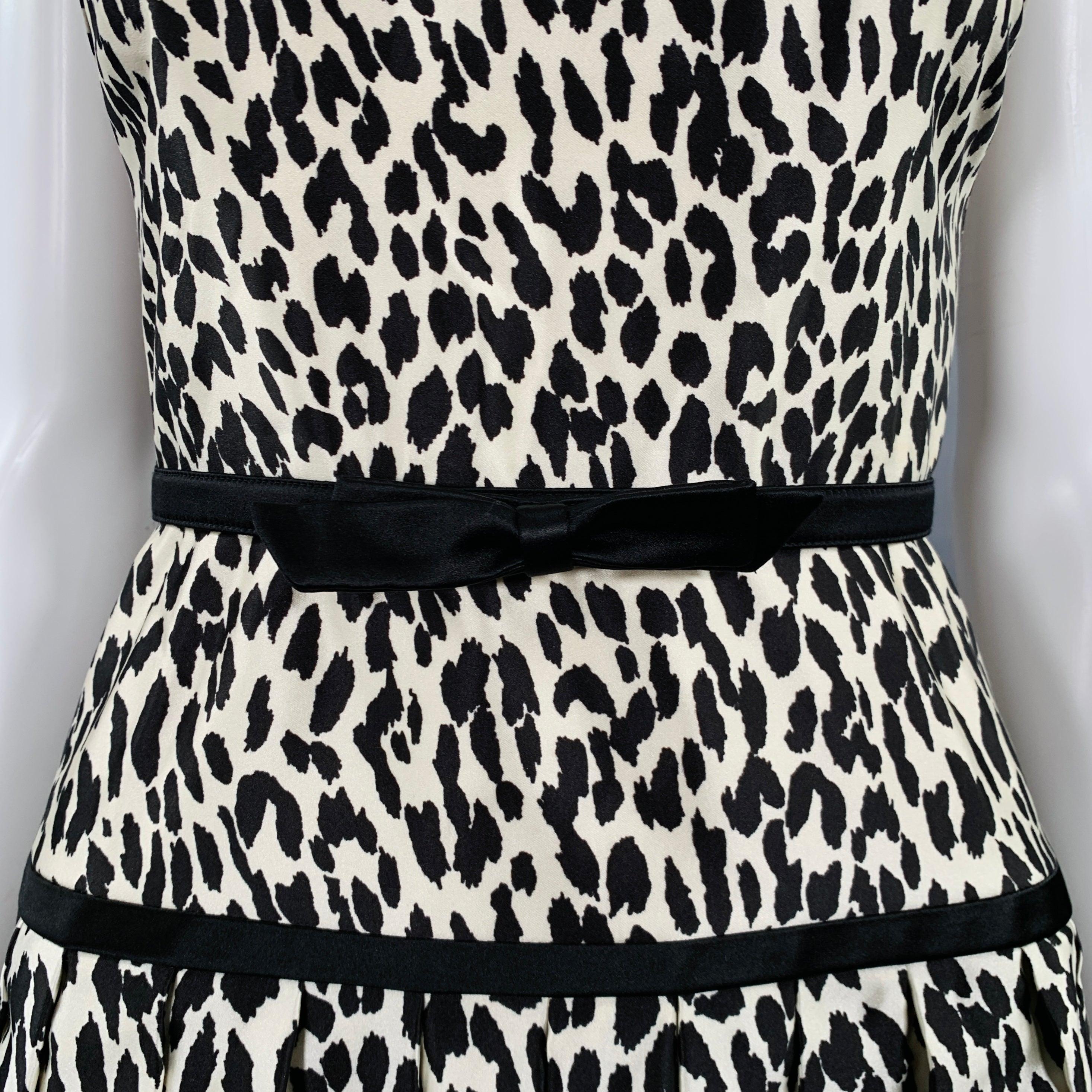 VALENTINO cocktail dress
in a white and black fabric featuring an animal print, halter top style, and bow details on back and belt with snaps.Excellent Pre-Owned Condition. 

Marked:   size not marked. Tags removed. 

Measurements: 
 
Shoulder: 7