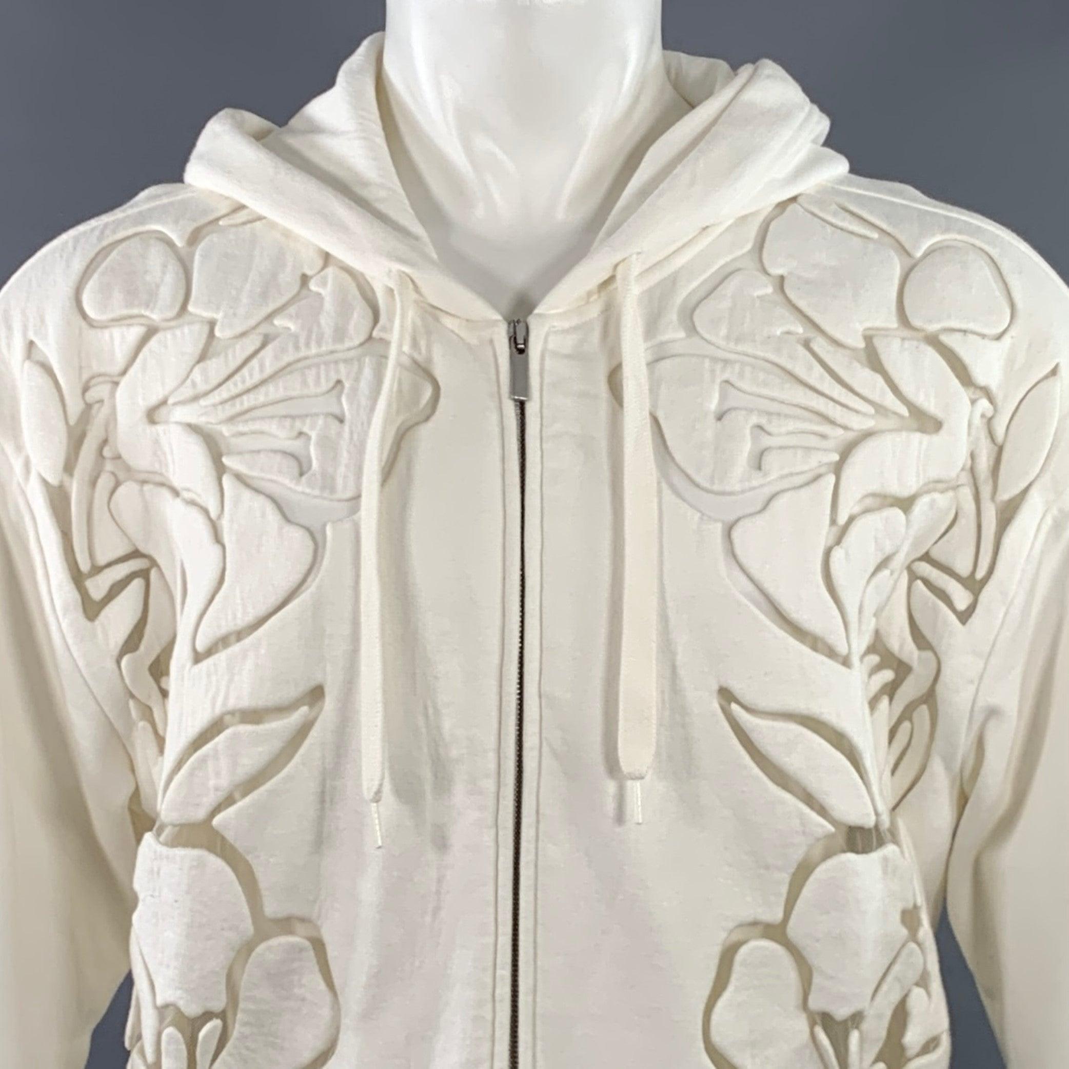 VALENTINO jacket
in a white cotton polyamide blend fabric featuring a hooded style, floral cutout design, oversized fit, and zip up closure. Made in Italy.Excellent Pre-Owned Condition. 

Marked:   S 

Measurements: 
 
Shoulder: 22 inches Chest: 50