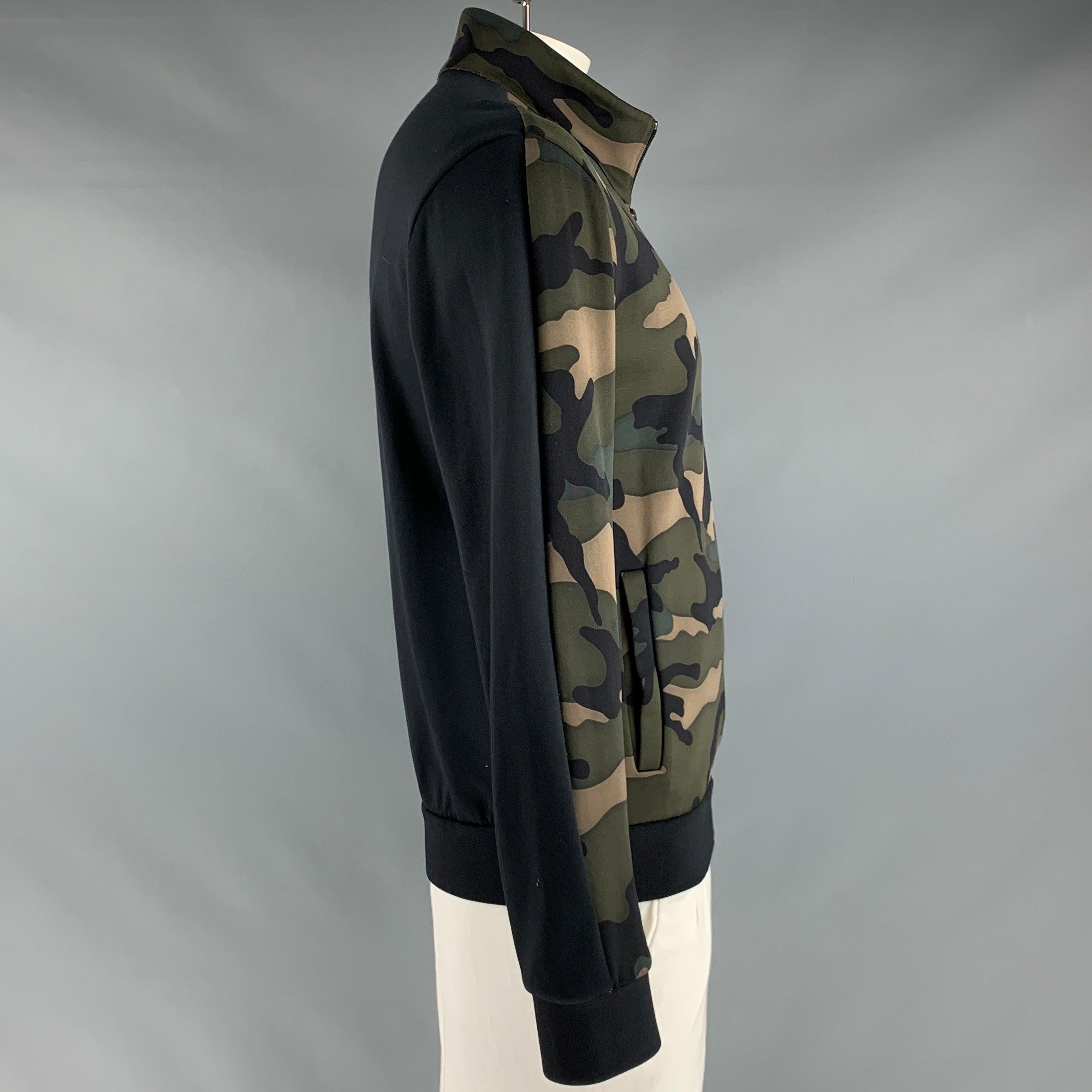 VALENTINO SPA jacket
in a green and brown cotton blend fabric featuring all over camo pattern, two pockets, ribbed cuffs, and a zip up closure. Made in Italy.Excellent Pre-Owned Condition. 

Marked:   XL 

Measurements: 
 
Shoulder: 21.5 inches 