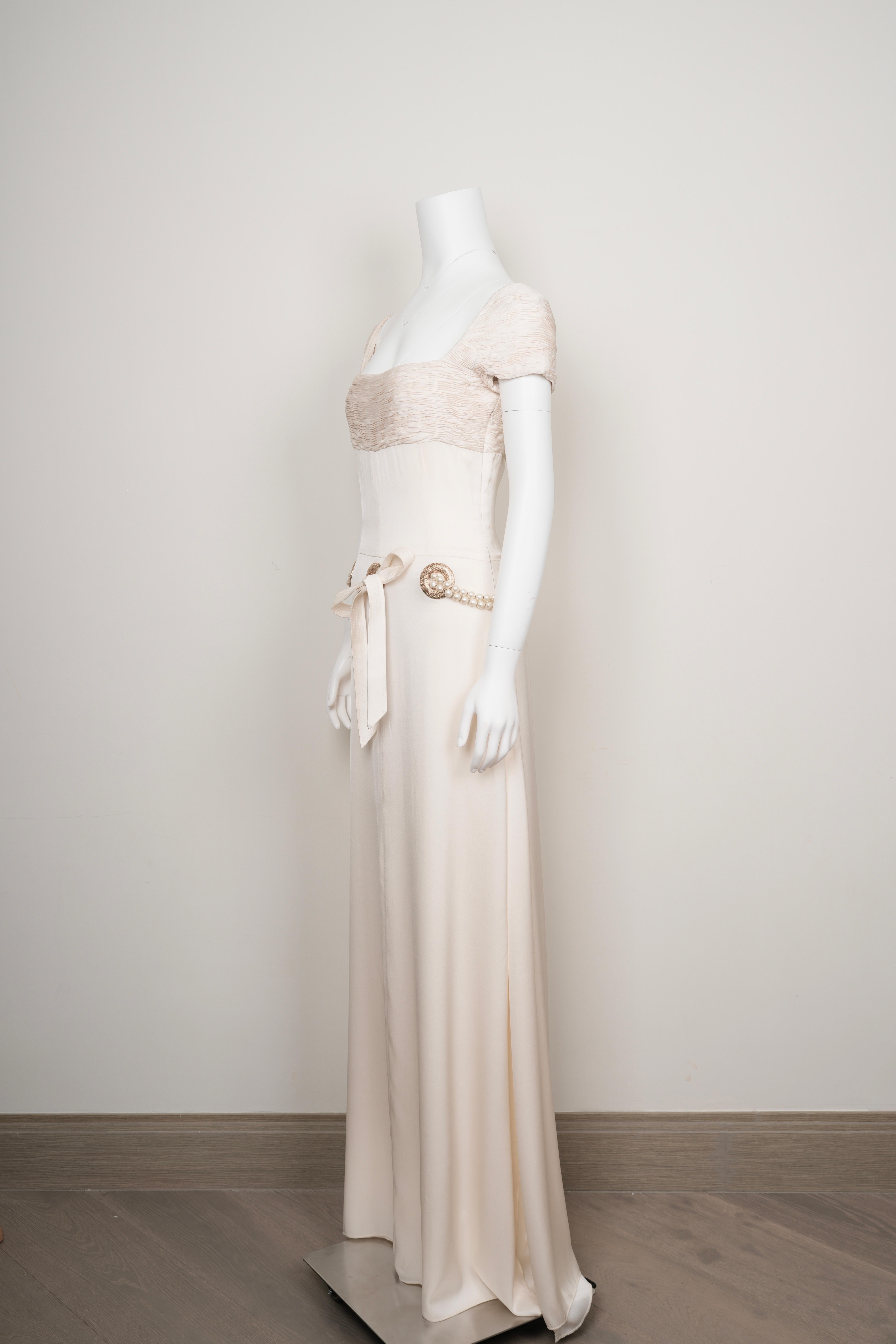 Cette robe en daim de soie ivoire de la Collection S 2005 de Valentino incarne l'allure tranquille et le savoir-faire méticuleux qui ont défini l'ère de la maison au milieu des années 2000. Coupée en taille M, la silhouette épouse et libère les