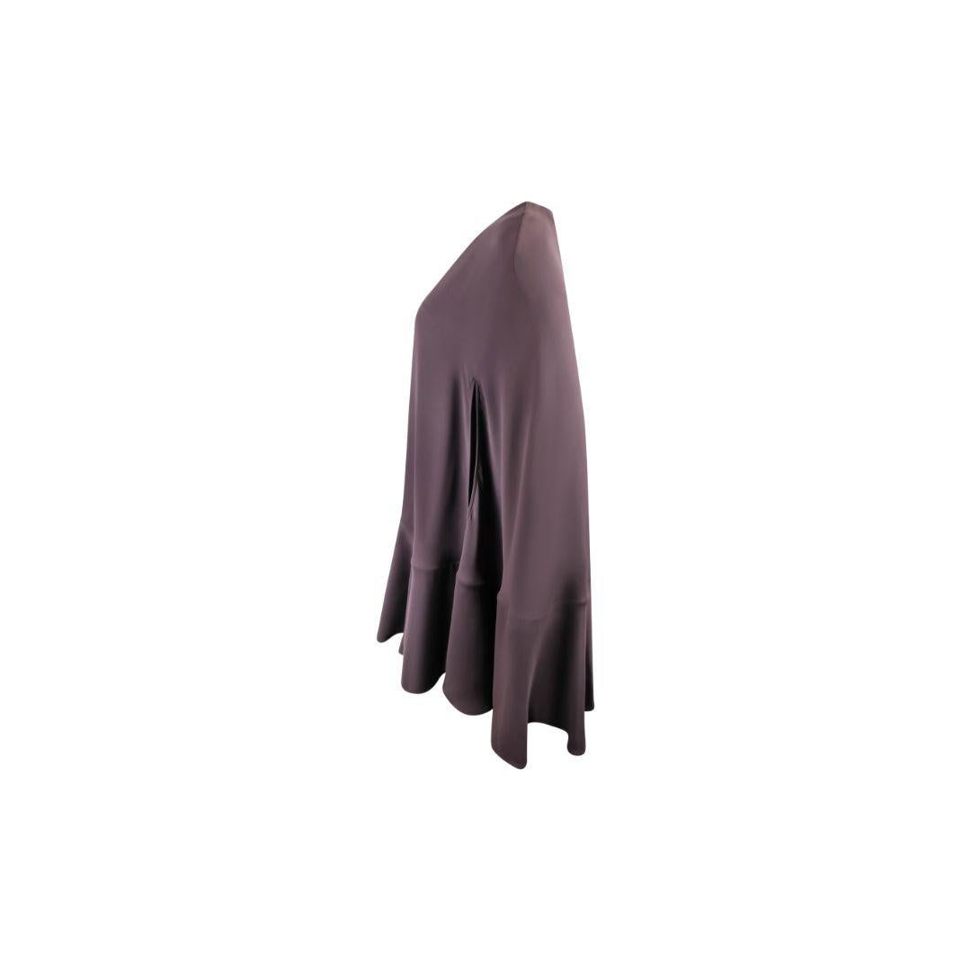 This Valentino Spring/Summer 2021 cape mini dress is crafted from luxurious silk chiffon, with discreet front armholes beneath the flowing, cape-like sleeves. The design features a high neckline and a subtly flared hemline that adds movement to the