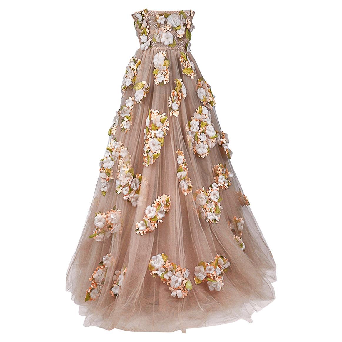 limited edition Valentino gown featured in nude tulle adorned with silk flowers.
Only 1 of 2 in the world created.
Strapless with the bodice of the empire waist covered in a fine lace.
This exquisite gown was worn one time and is a timeless