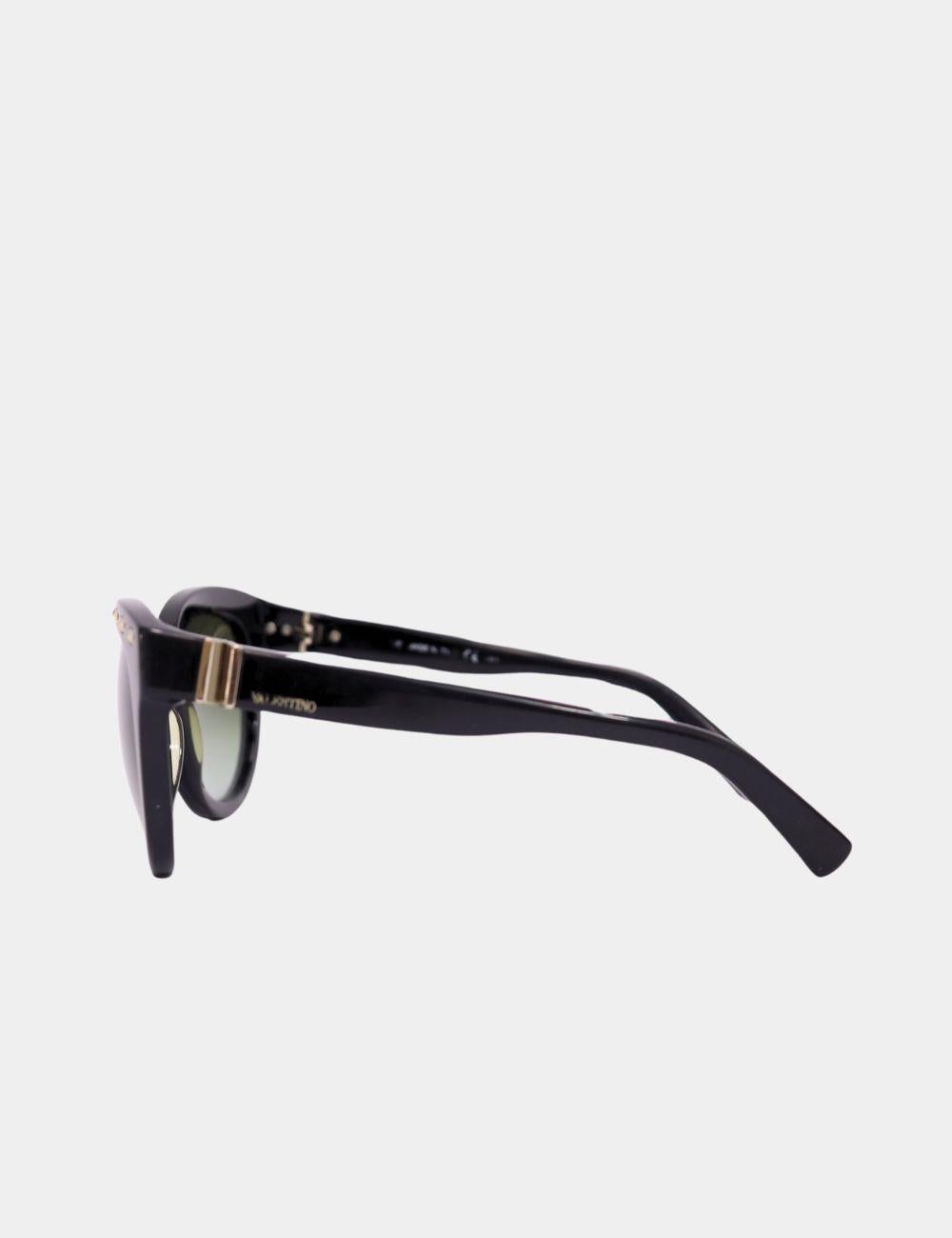 Channel bold Italian glamour with these Valentino Black Studded Sunglasses. Featuring a chic cat-eye silhouette, these statement shades are adorned with signature Valentino Rockstud detailing along the browline and temples. Crafted from glossy black