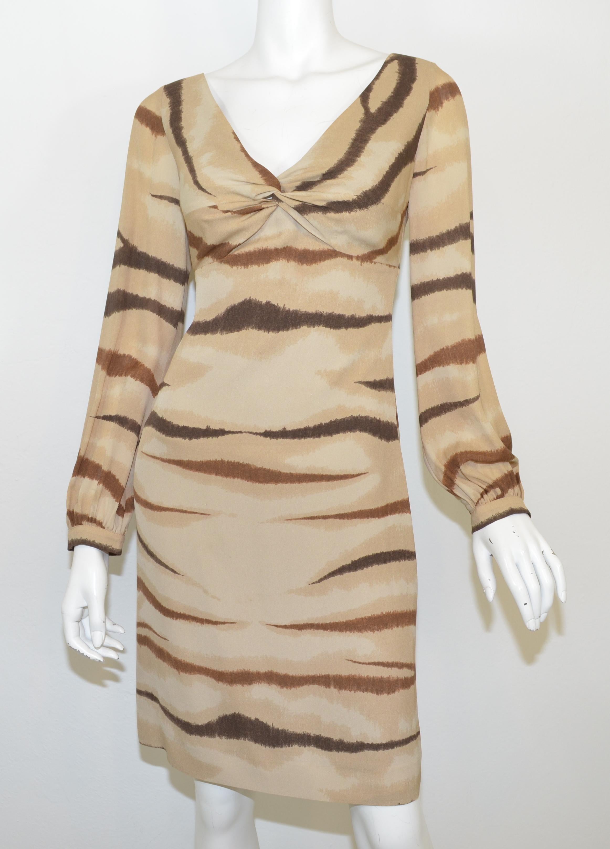Valentino dress is featured in a tan/brown color with an animal print throughout, a V-neckline, full lining, and a side zipper fastening. Dress is a size 40, made in Italy, and 100% silk.

Measurements: 
bust 34'', waist 28'', hips 34'', sleeves
