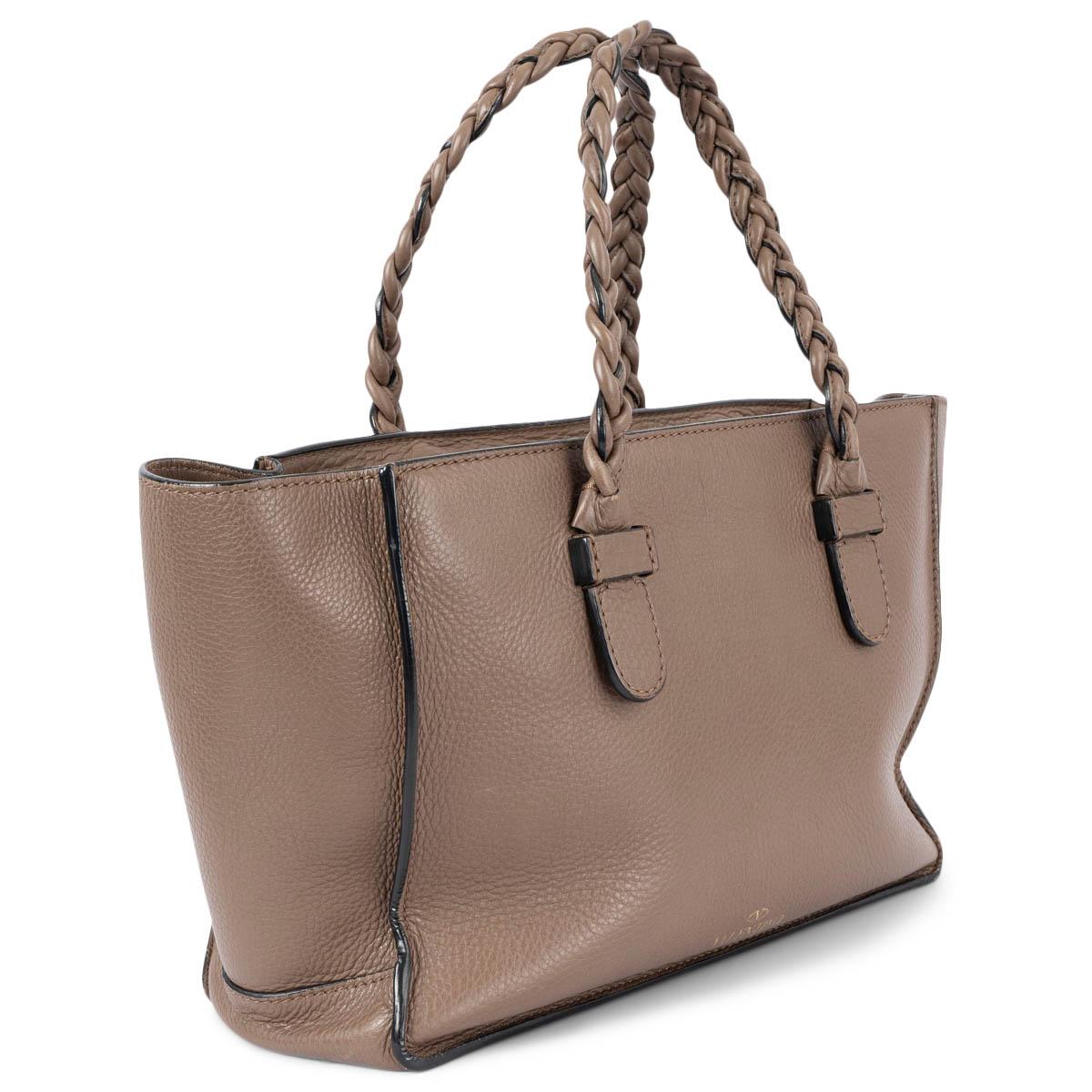 100% authentic Valentino 2014 To Be Cool Small tote bag in dark taupe grained leather. The design features braided leather handles, large sides and a removable pocket. Opens with a top zip and offers a spacious leather interior with zip closure and