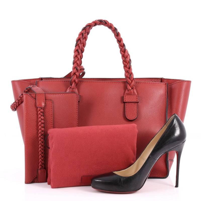 This authentic Valentino To Be Cool Tote Leather Small is a stylish and iconic tote made for everyday excursions. Crafted from red leather, this feminine tote features dual braided top handles, gold-stamped logo at front, and gold-tone hardware