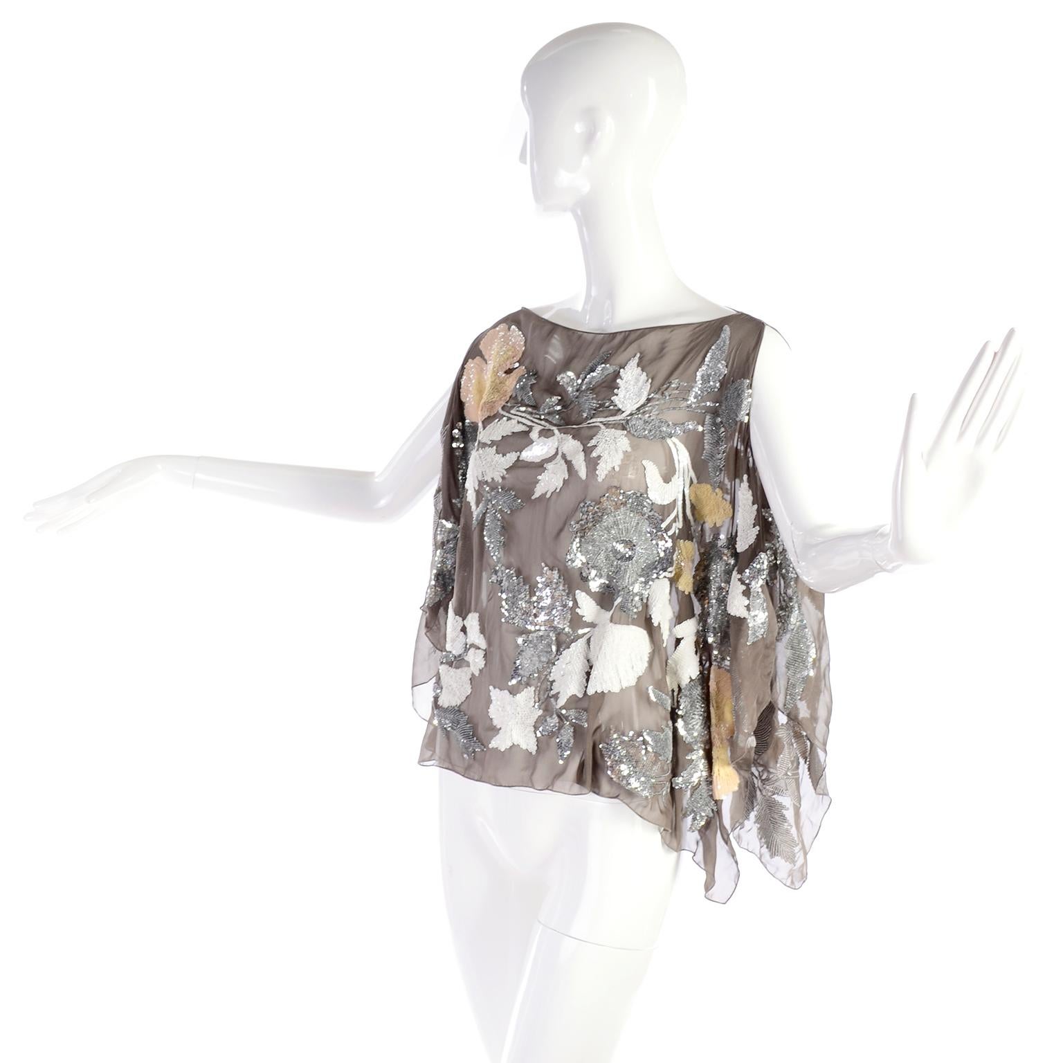 This exquisite sheer fine silk taupe Valentino top is covered in silver metallic and peach and white iridescent sequins. This elegant piece can be worn over a tank or just with a pretty bra. You can wear it with an evening skirt, evening trousers,