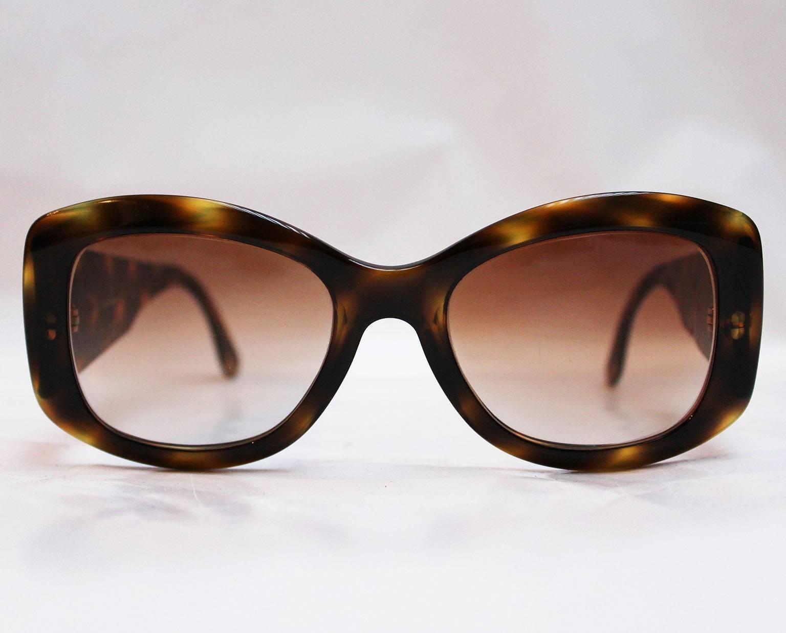 A great pair of sunglasses by Italian fashion house Valentino. In wonderful shades of brown, with wide arms these glasses are a chic addition to any wardrobe. On the inside of the right arm is stamped, Valentino , made in Italy, and on the inside of