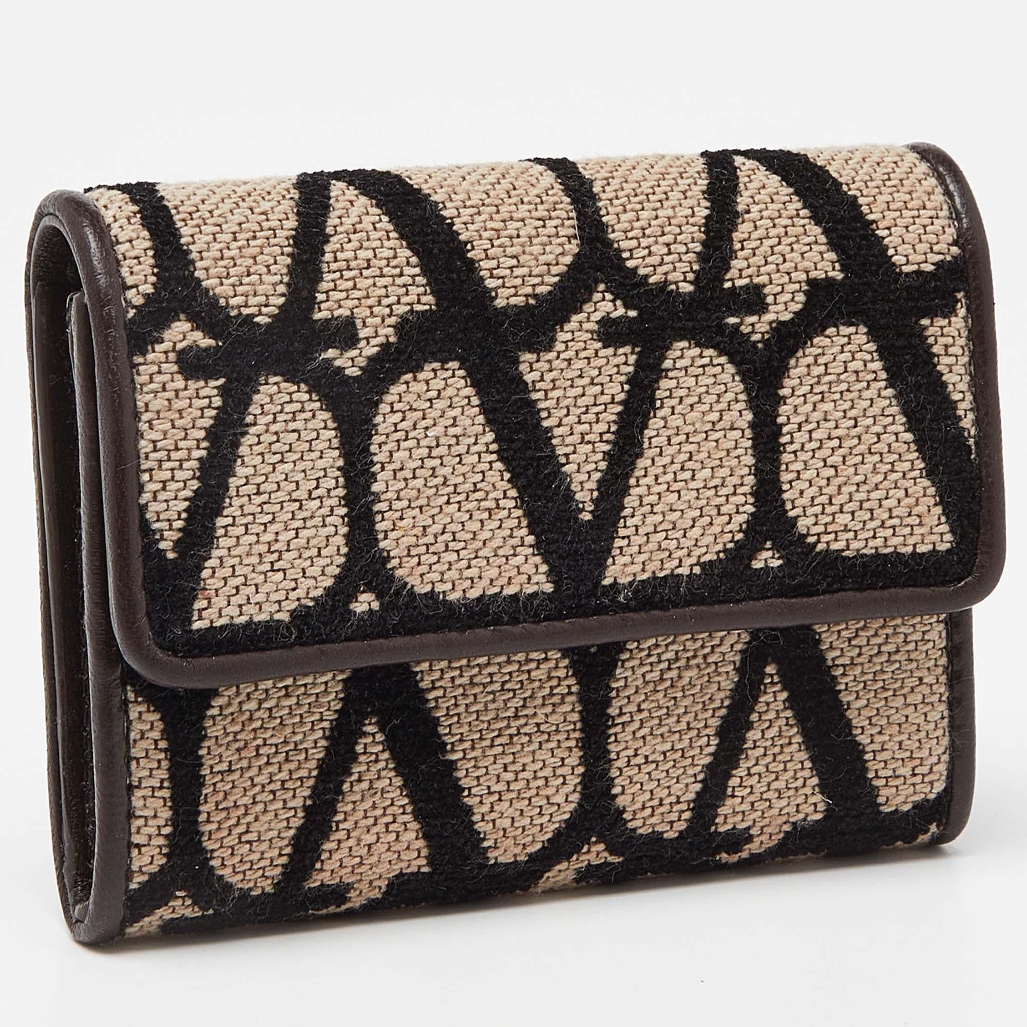 Beautifully shaped into a petite silhouette and augmented with iconic brand motifs, this wallet from the House of Valentino will surely be your favorite accessory. It is made from tri-color fabric and leather, with a leather interior.

