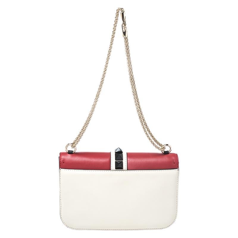 If you are looking for a bag with a blend of modern style and class, this Valentino creation is the answer. Crafted from leather, this tri-color piece comes with a gold-tone chain and a flap with a push-lock to secure the well-sized leather