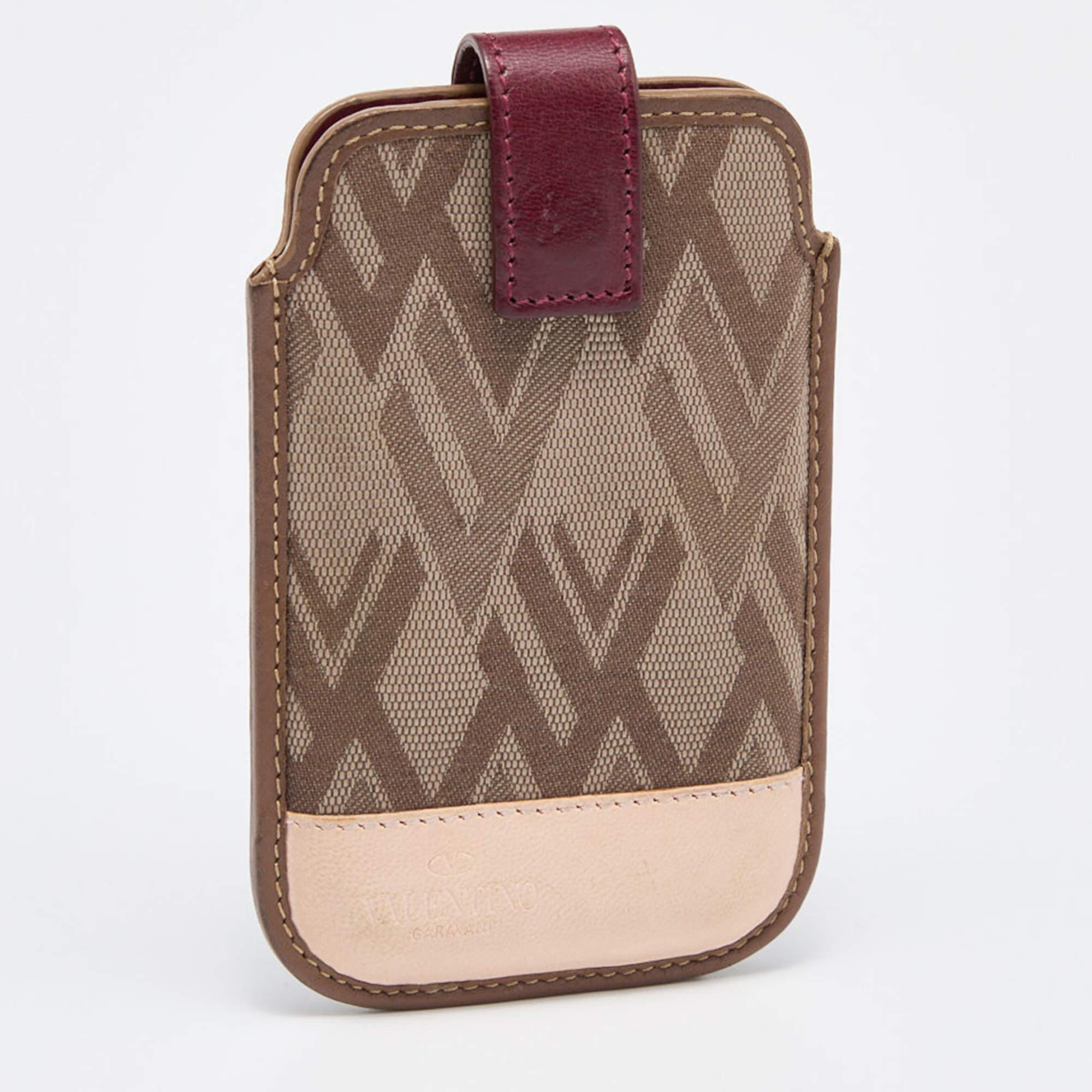Hold your phone safely using this Valentino phone cover. It is stitched beautifully using V print fabric and leather.