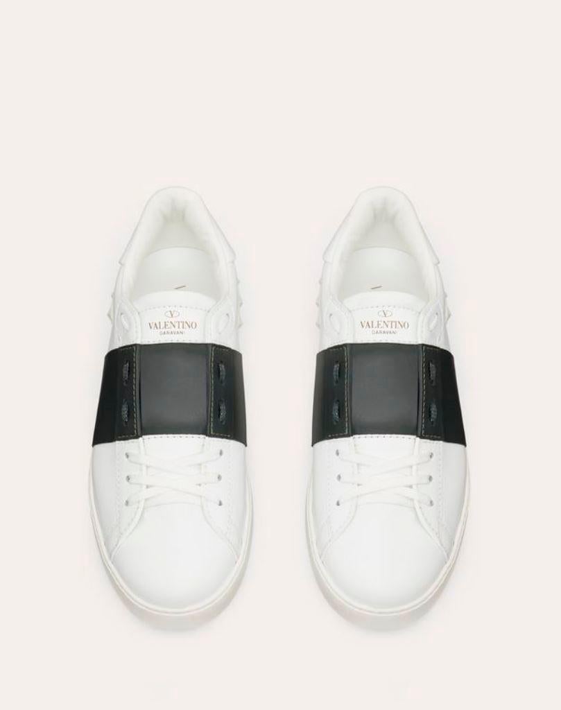 Look ready to take on the world in style when you step out wearing these Valentino low top sneakers with your casuals. Crafted in leather and designed with a contrast band and the signature stud details, these shoes are luxe and comfortable to walk