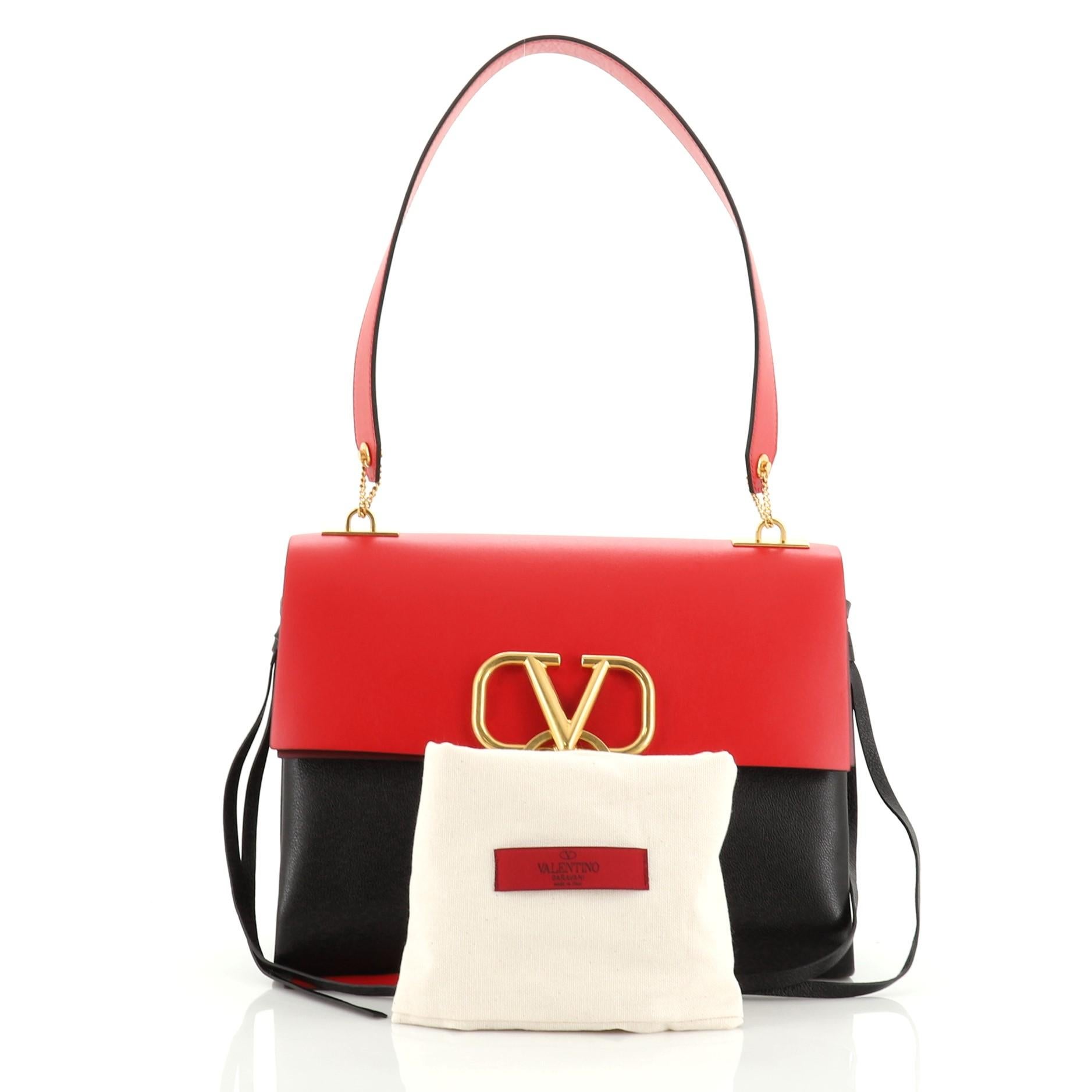 This Valentino V-Ring Shoulder Bag Leather Medium, crafted from black, red and multicolor leather, features leather shoulder strap, metal logo adorned with ring and tie, and gold-tone hardware. Its clip closure opens to a black and red leather