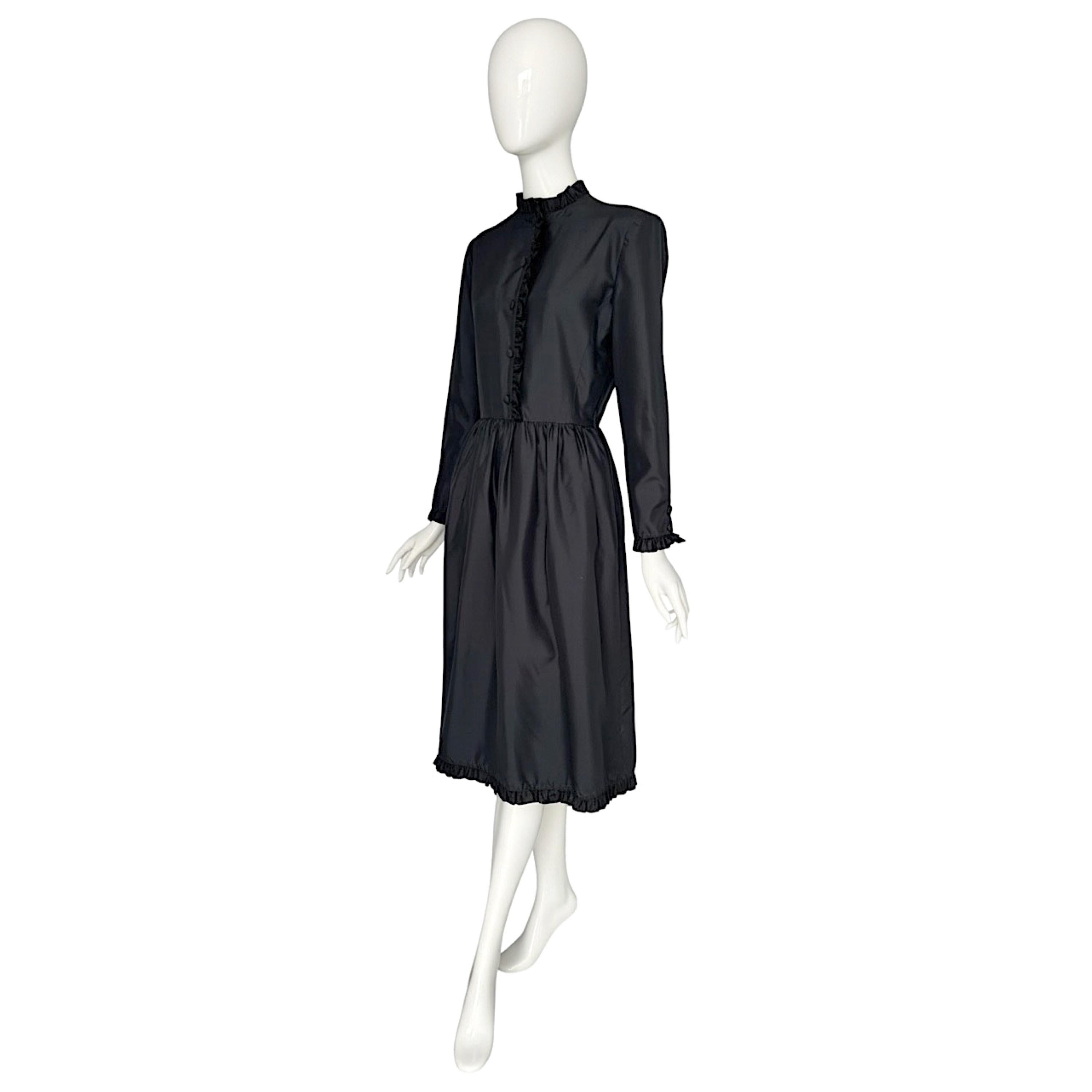 Valentino Vintage 1980s Black Silk Dress
Elegant 1980s Valentino dress crafted from lightweight crispy black silk. Features delicate ruffles along the neckline, front closure, hem, and cuffs. Front closure and cuffs have covered silk buttons in