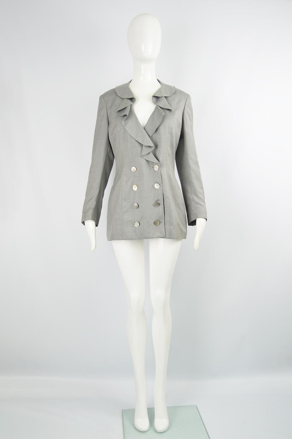 A chic vintage Valentino Boutique jacket from the 80s in a luxuriously fine grey wool with ruffles at the front and a silk lining - perfect for the office or as a sophisticated look in spring and summer. 

Size: Marked UK 10 as it was sold to a UK