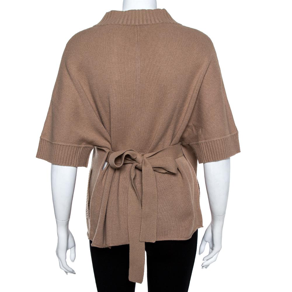 Made by Valentino, a stylish cardigan like this one is a fashion must-have. This subtly-designed beige creation has elbow-length sleeves, a button front and a high neckline. Make an edgy style statement when you step out wearing this cashmere