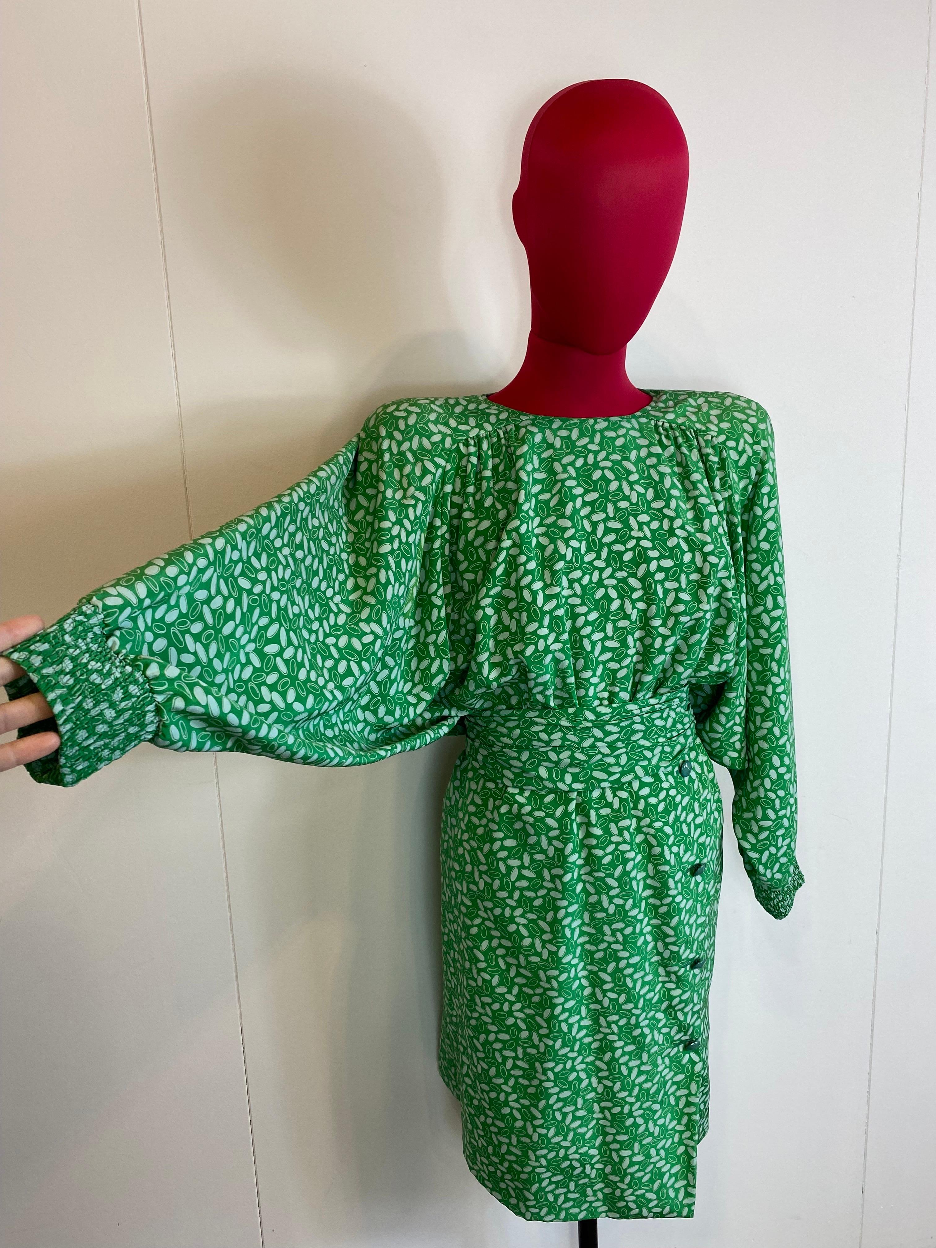 Vintage Valentino dress, green and white pattern. 
With straps and belt. 
Batwing sleeves.
Back closure with concealed button placket and zip. 
The label of the composition is missing but it is made of silk. 
It shows signs of normal use but is
