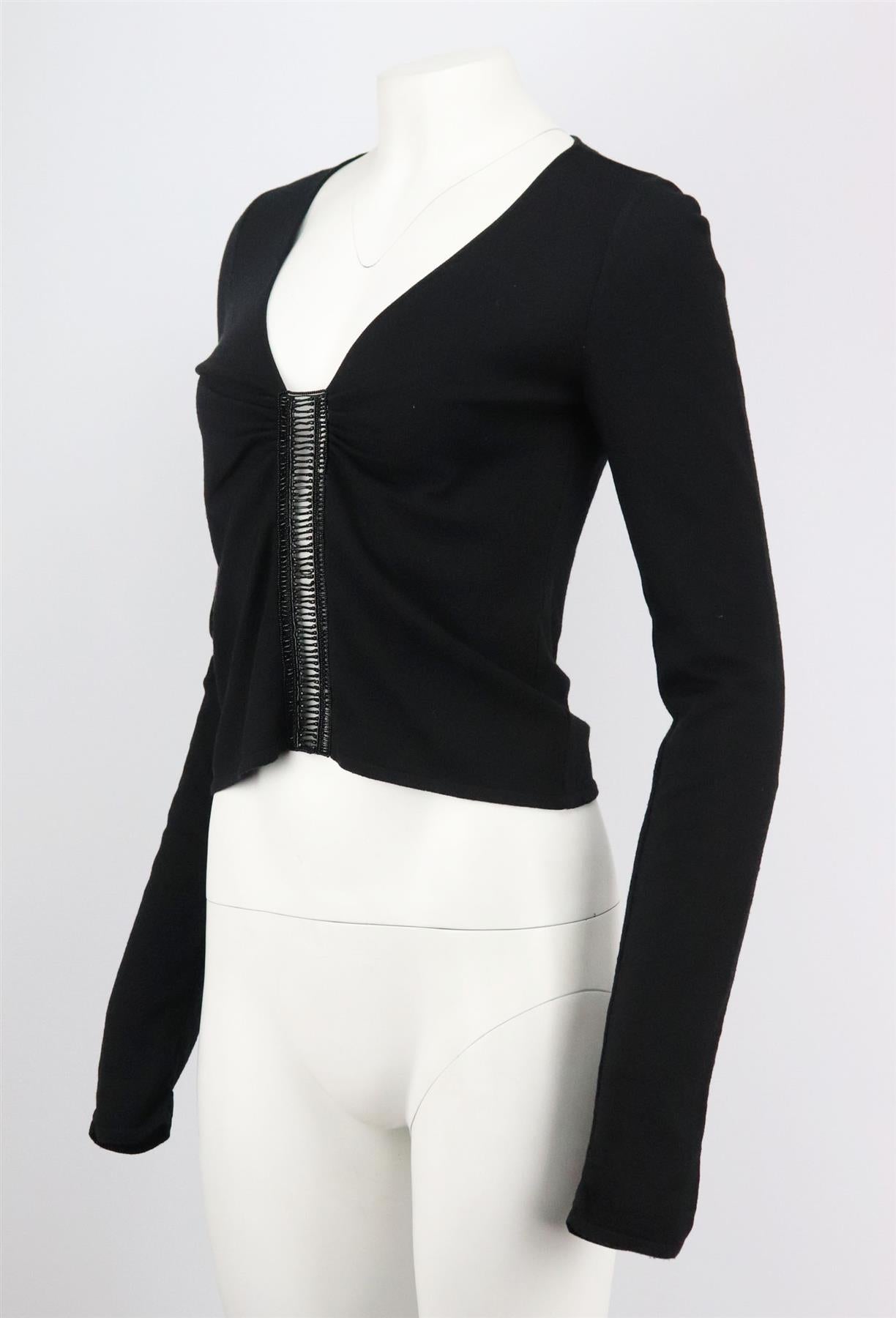 This vintage top by Valentino is made from bead embellished wool-blend, it is cut for a sexy silhouette with slightly cropped hem, plunging neckline and ruched detail at the front. Black wool-blend. Slips on. 80% Wool, 20% polyamide. Size: Medium