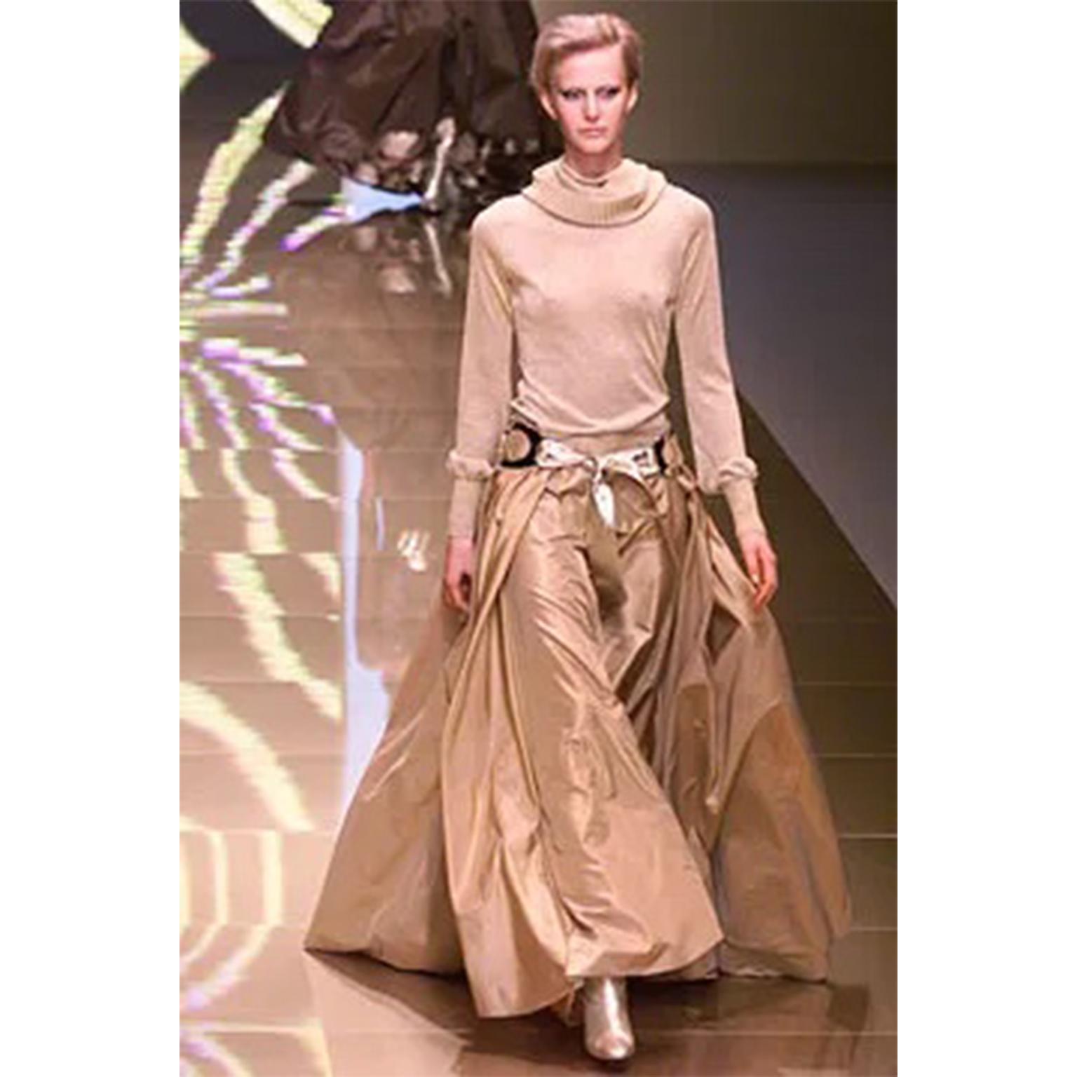 This stunning vintage Valentino Garavani belt is from the Fall 2002/03 runway collection. The belt is in a luxe metallic gold and features two oversized silver buckles. Similar buckles were used in many accessories from this collection.	The belt