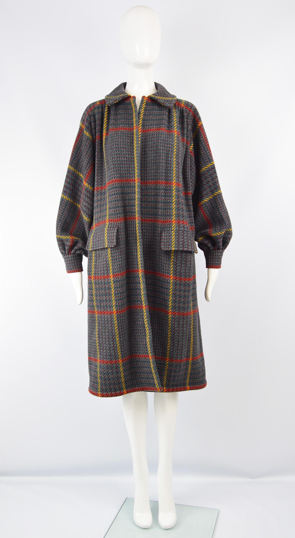 A stunning vintage women's collared coat from the 80s by luxury Italian fashion designer, Valentino. In a grey lightweight wool with a red and yellow checked pattern throughout. With an edge to edge design that has no fastenings and is meant to