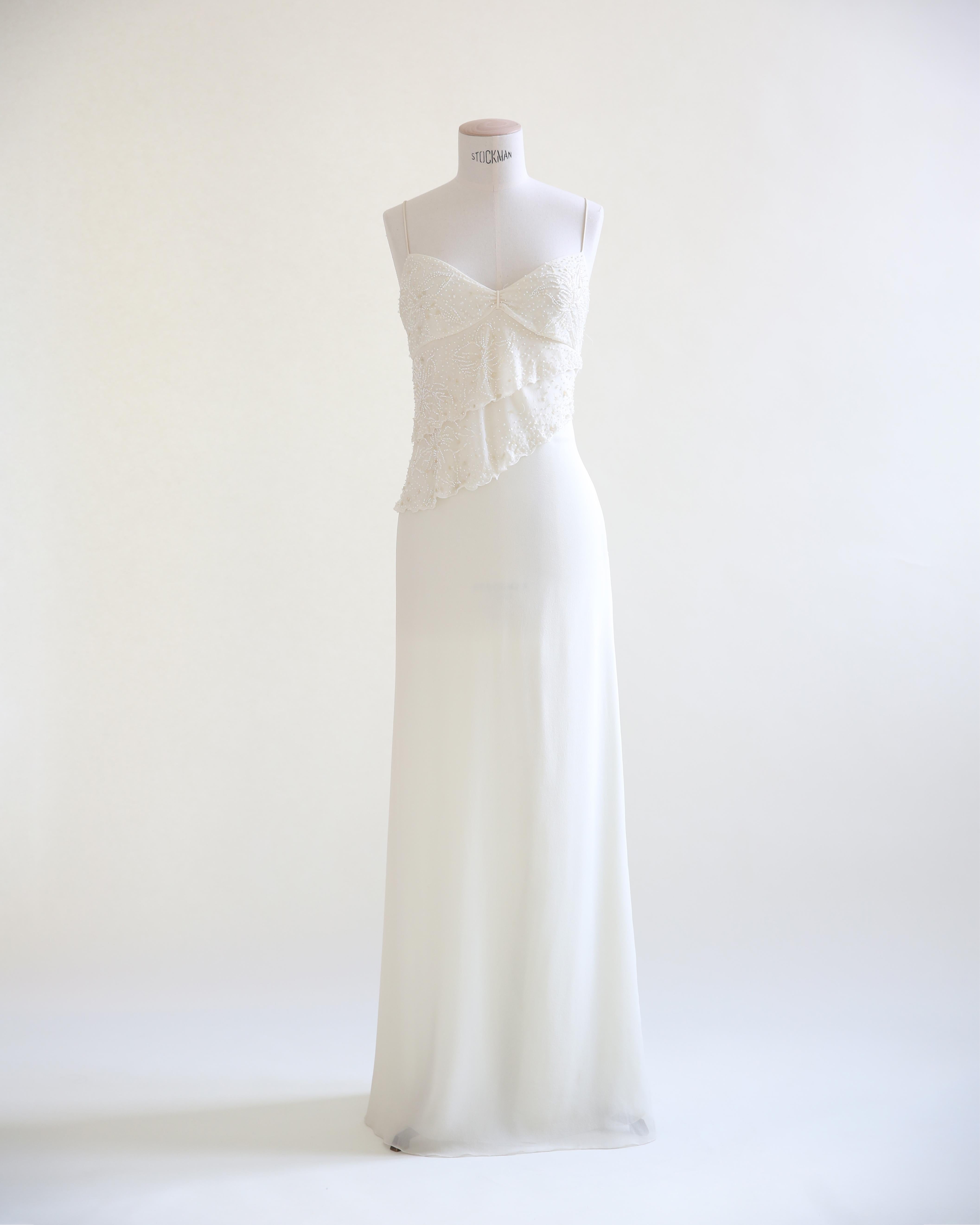 LOVE LALI VINTAGE

Beautiful vintage long dress by Valentino in ivory that would work superbly as a wedding dress. Composed of three sheer layers, 2 of which are silk, with the third being the lining. Very simply and elegantly cut with thin