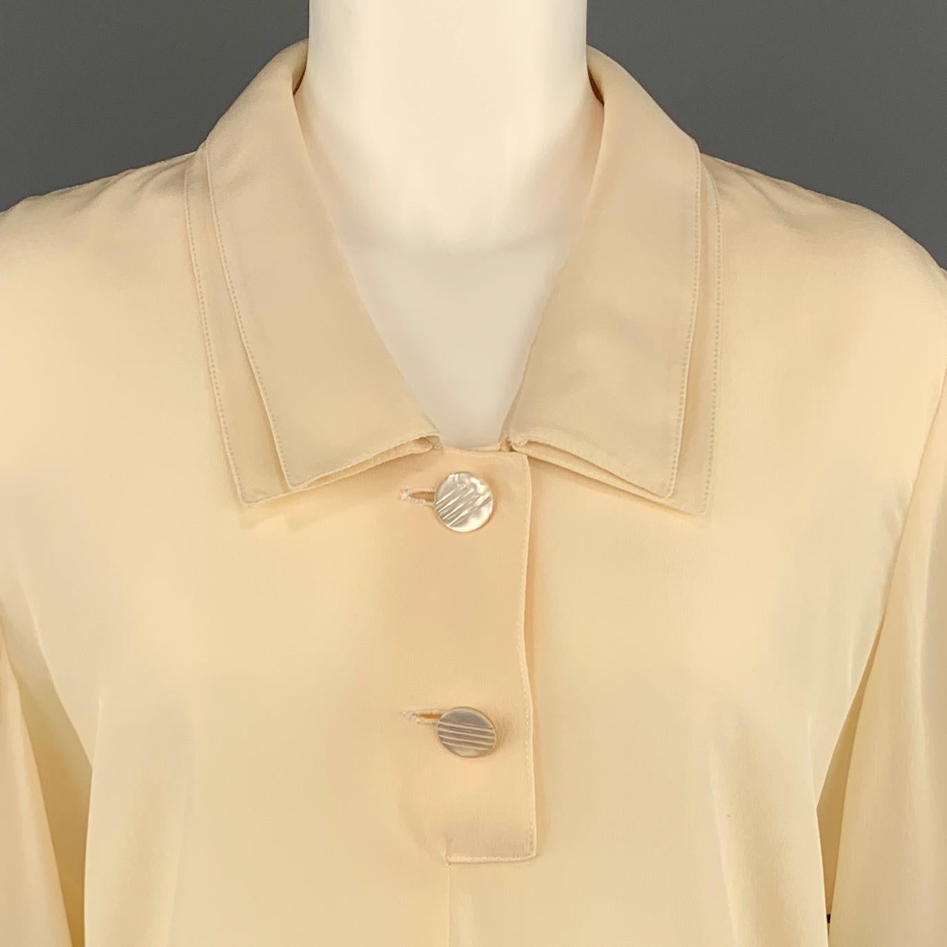 Vintage VALENTINO blouse comes in cream beige silk with a double pointed collar, two button half closure, and short sleeves. Spot. As-is. Made in Italy.
 
Good Pre-Owned Condition.
Marked: (no size)
 
Measurements:
 
Shoulder: 18 in.
Bust: 42