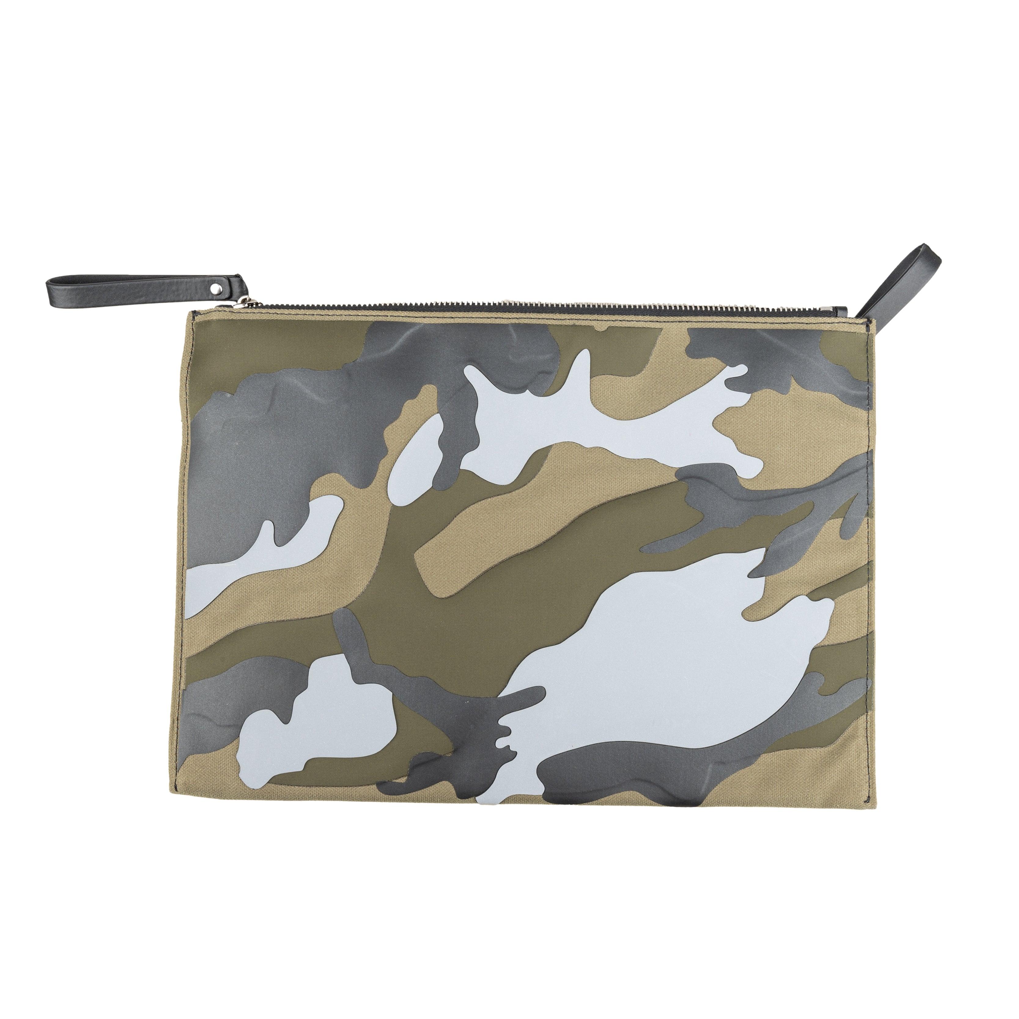 This Valentino pouch bag features a multi-shaded green camouflage pattern, while the VLTN logo adds a touch of brand flair. The zipper closure ensures secure storage for your belongings. Expertly crafted with high-quality materials, this versatile