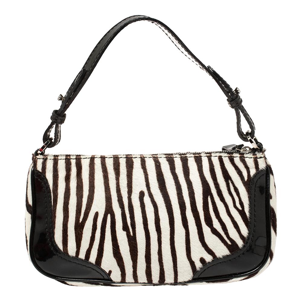 Valentino is one name that we can always count on for the latest in trends and the most versatile styles that stand the test of time. This shoulder bag is one such creation featuring a gorgeous zebra-printed calfhair body accented with a front flap