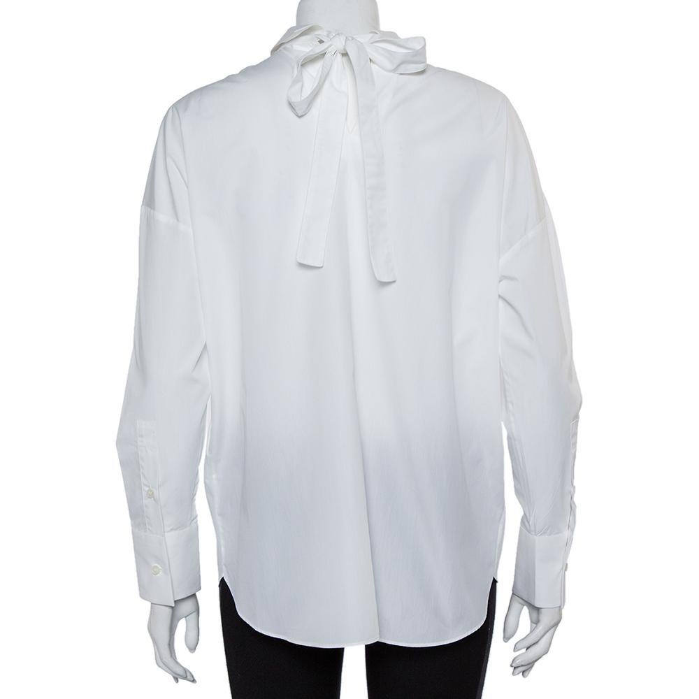 Combining sophistication with a whole lot of style, this Valentino shirt will help you project a refined look. It comes made of 100% cotton and features sharp collars, front button fastenings, long sleeves, and a tie detailing at the back. It will