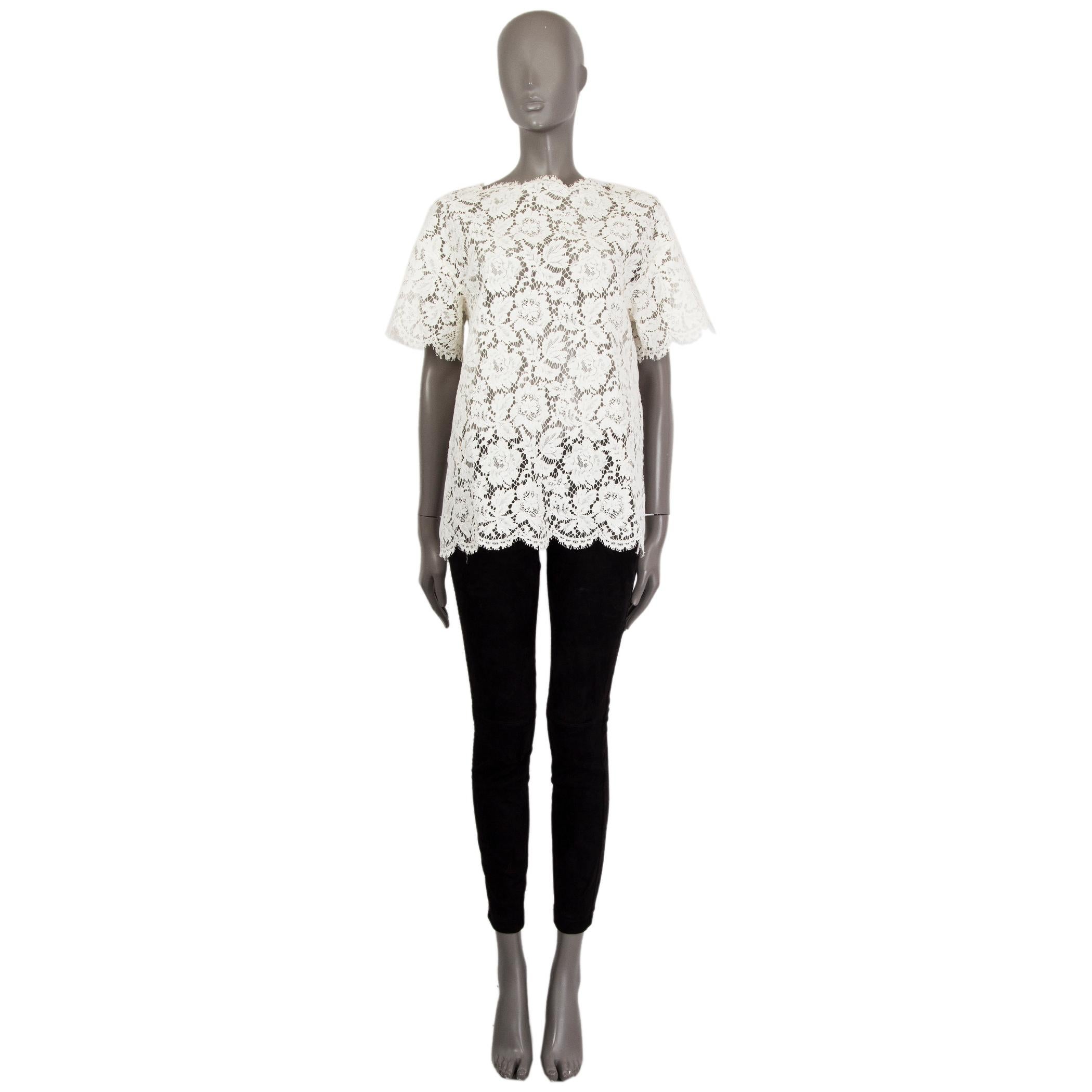 Valentino short-sleeve lace-top in off-white cotton-viscose blend (assumed as tag is missing) with a jewel-neck. Has two slits with bows on the back. Lined in polyamide (assumed as tag is missing). Has been worn and is in excellent condition. 

Tag