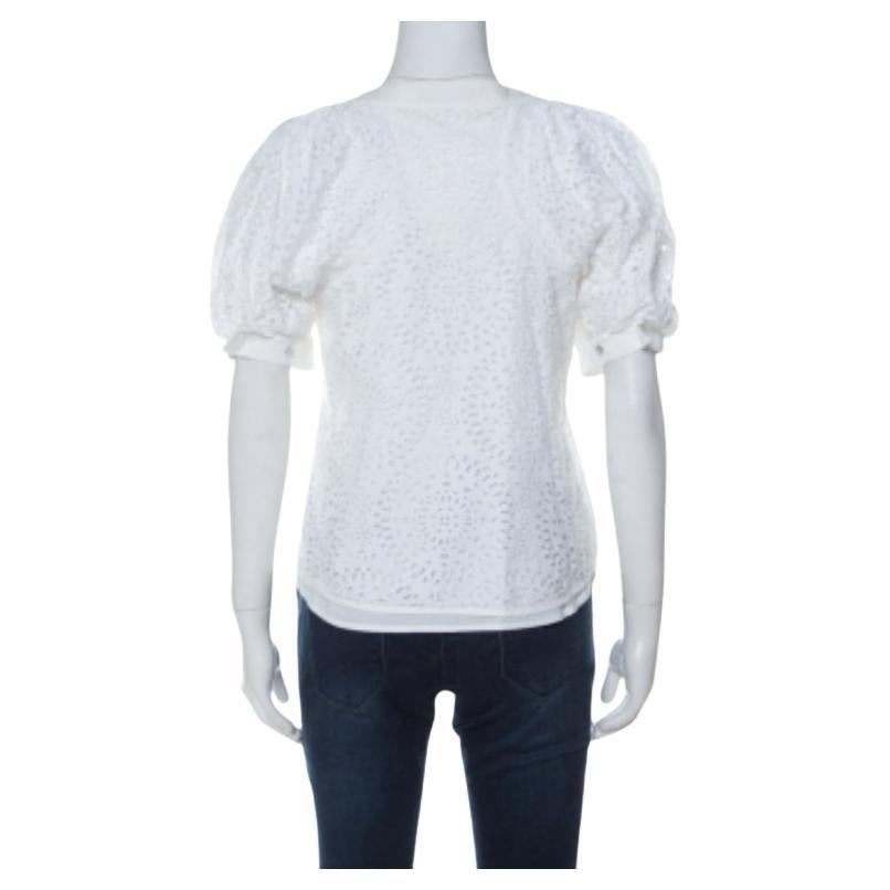 Ce magnifique top Valentino reste fidèle à son style à la fois audacieux et féminin. Confectionné en coton mélangé, ce haut blanc présente une silhouette flatteuse. Il présente une encolure simple et des manches bouffantes. Il vous ira à merveille