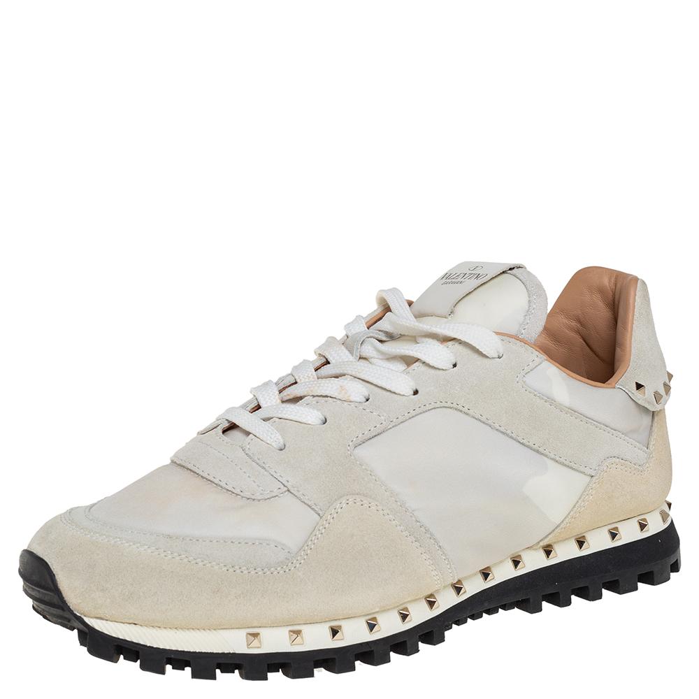 Ace the sneaker game in these from Valentino! These women's sneakers are crafted from white suede and nylon and feature round toes and lace-ups on the vamps. They flaunt the signature Rockstud detailing on the counters and midsoles and come equipped