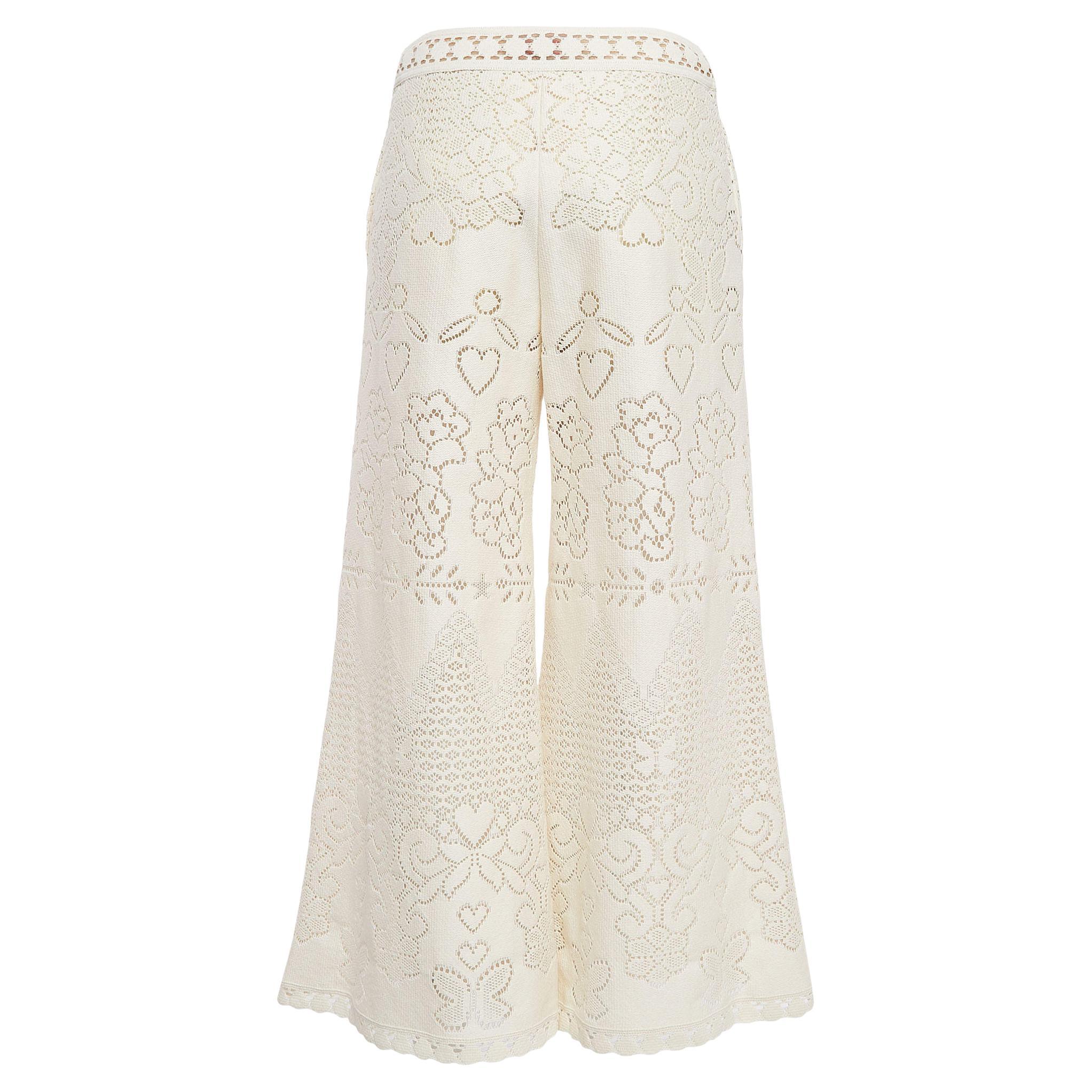 The Valentino pants epitomize chic sophistication. Crafted with meticulous attention to detail, they feature delicate eyelet knit fabric that gracefully flows with every step. Effortlessly stylish, they elevate any ensemble with their timeless